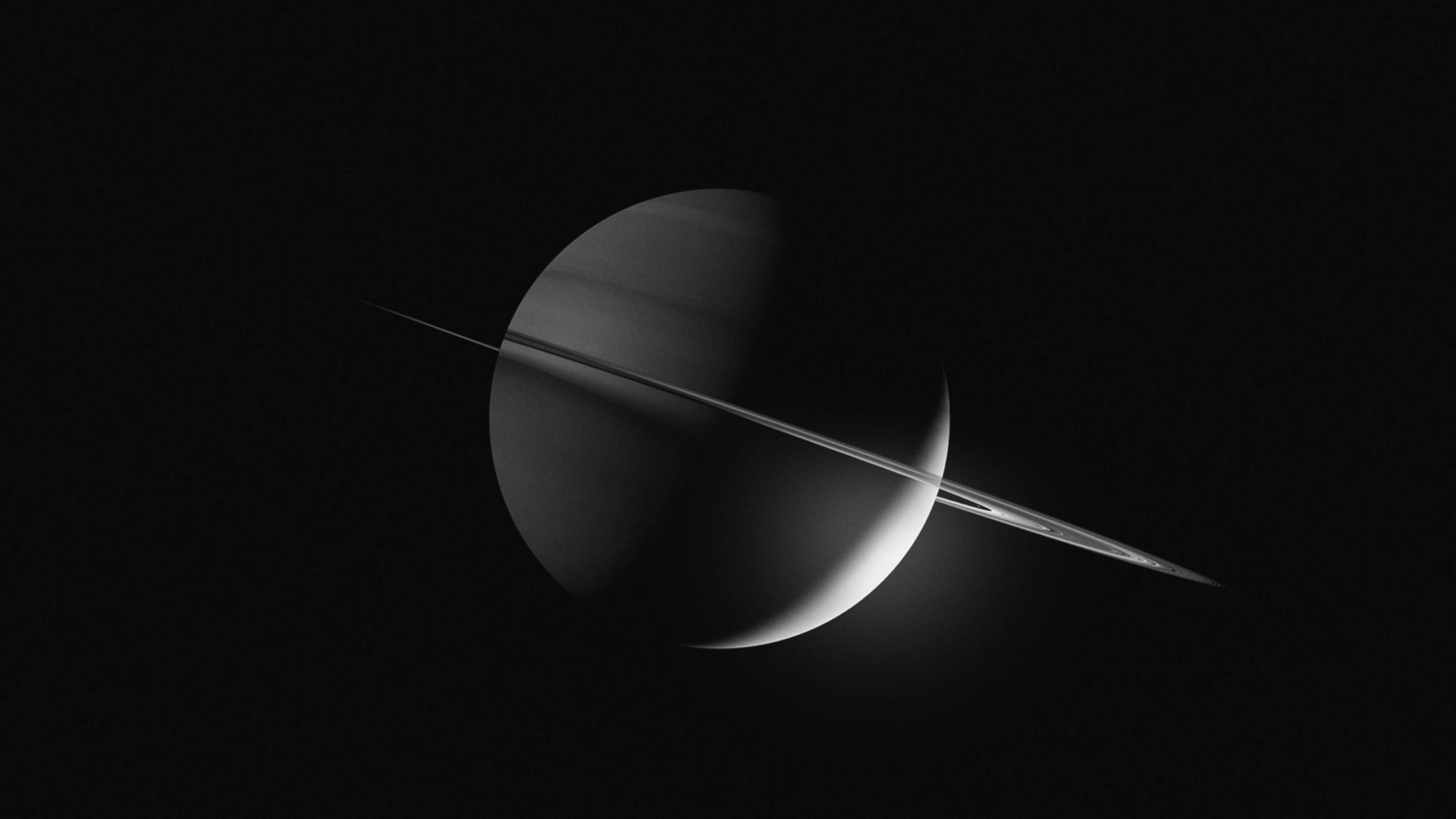 土星 桌布 壁紙 — 土星的黑白景觀，其標誌性環帶橫跨行星，背景為黑色虛空。