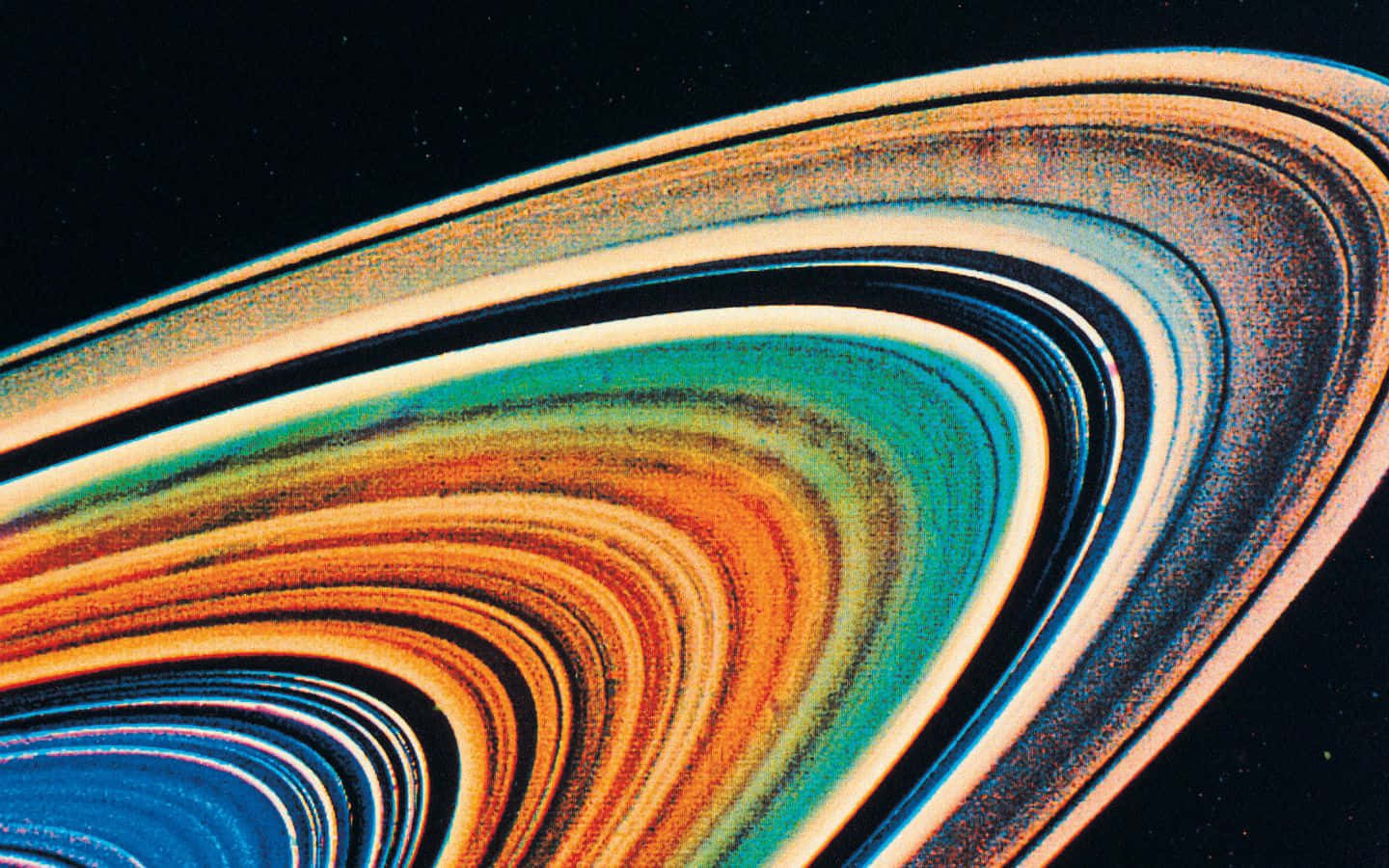 1440x900 桌布 壁紙 — 土星色彩繽紛的環在繁星點點的黑色虛空中旋轉的特寫。