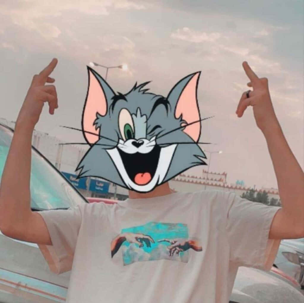 Tom Cat 桌布 壁紙 — 在停車場黃昏時分，戴著湯姆貓臉部濾鏡的人向上指。