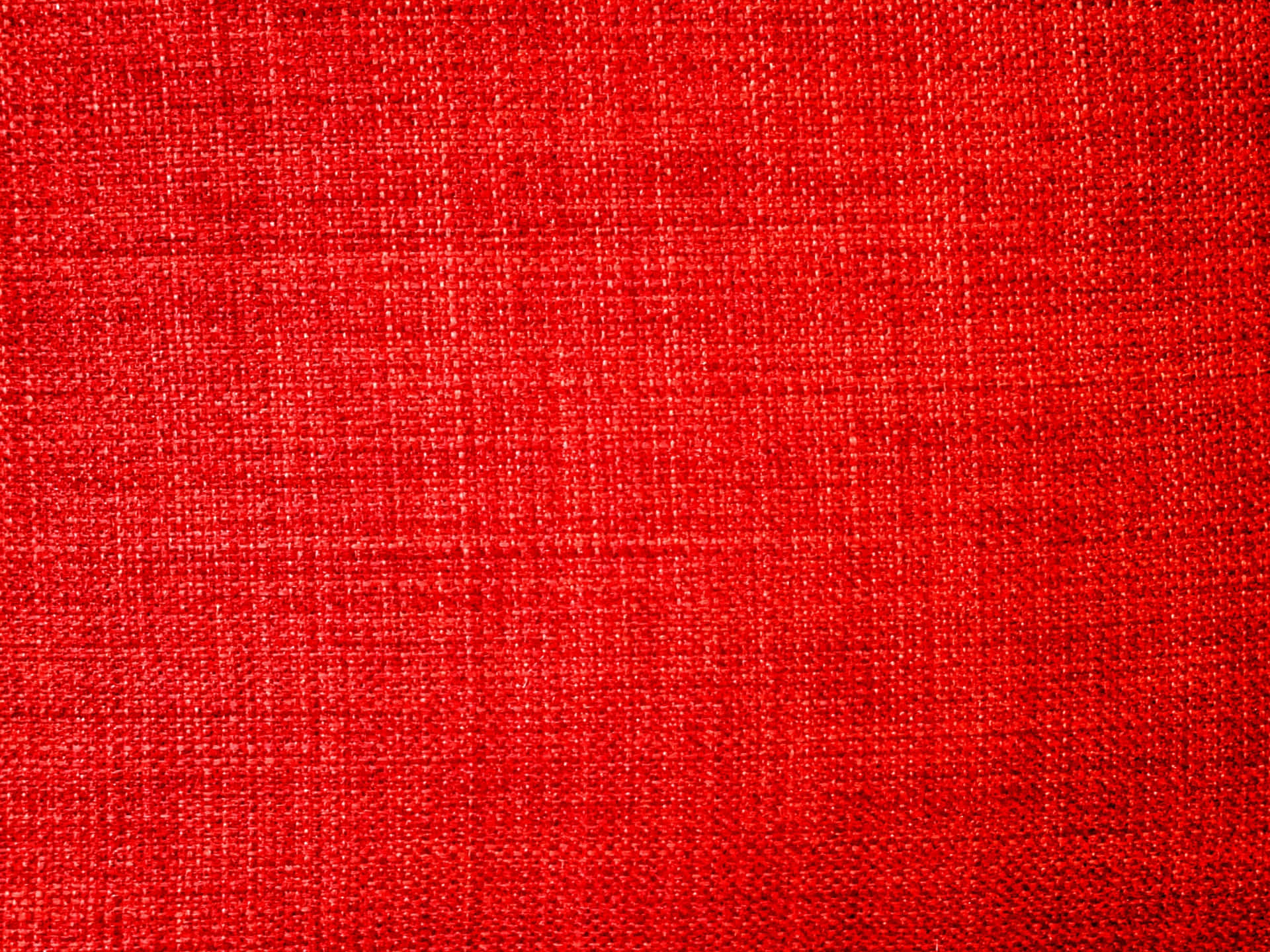 Fabric 桌布 壁紙 — 在均勻照明下，具有可見編織紋理和微妙色調變化的鮮紅色亞麻布料。