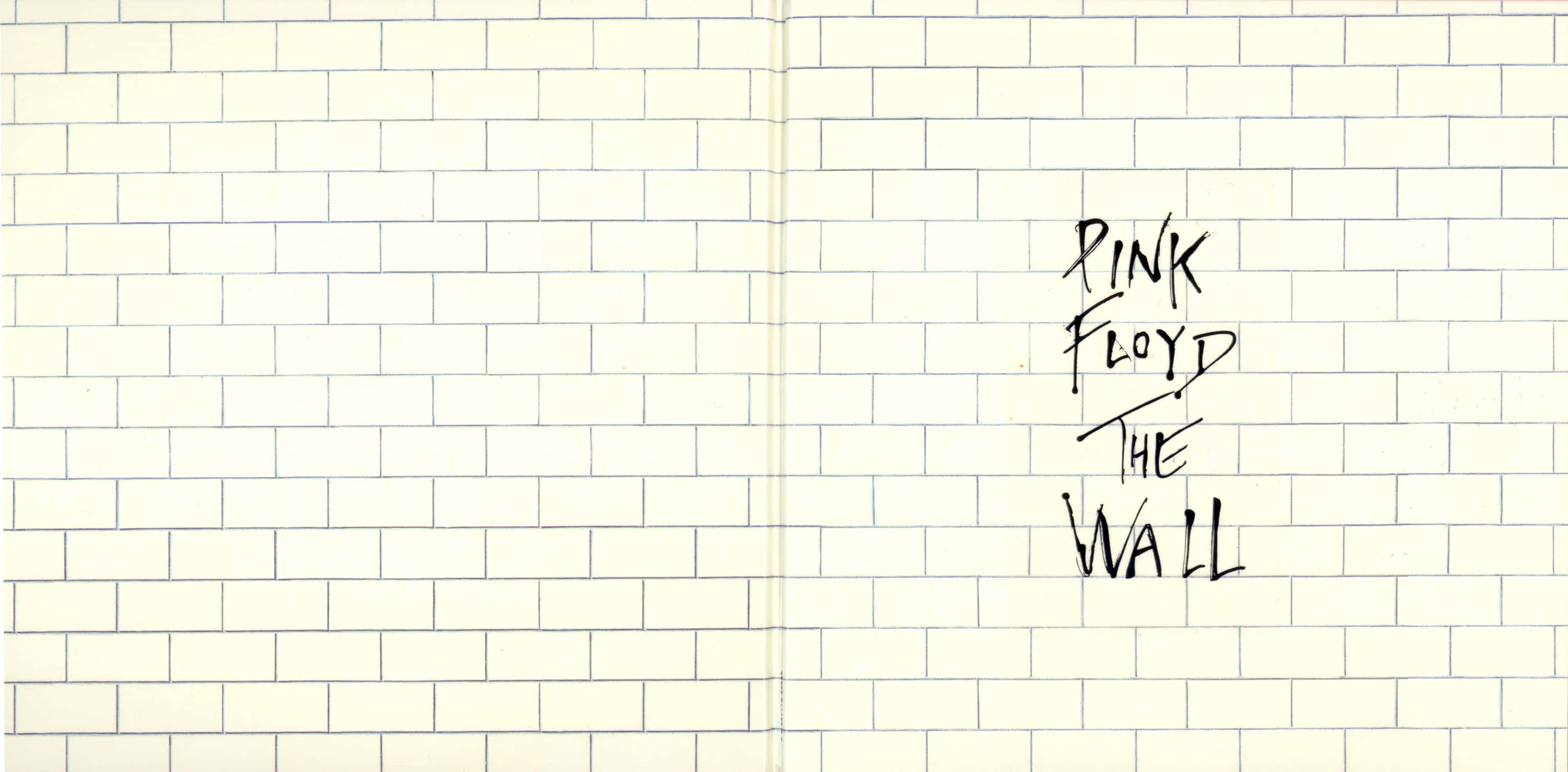 桌布 壁紙 — 在奶油色磚牆背景上以黑色墨水手寫的Pink Floyd The Wall文字。