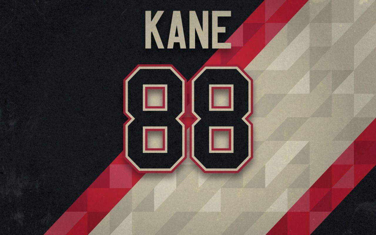 運動 桌布 壁紙 — 在幾何對角線背景上，大膽的黑色、紅色和奶油色 'KANE 88' 球衣號碼。