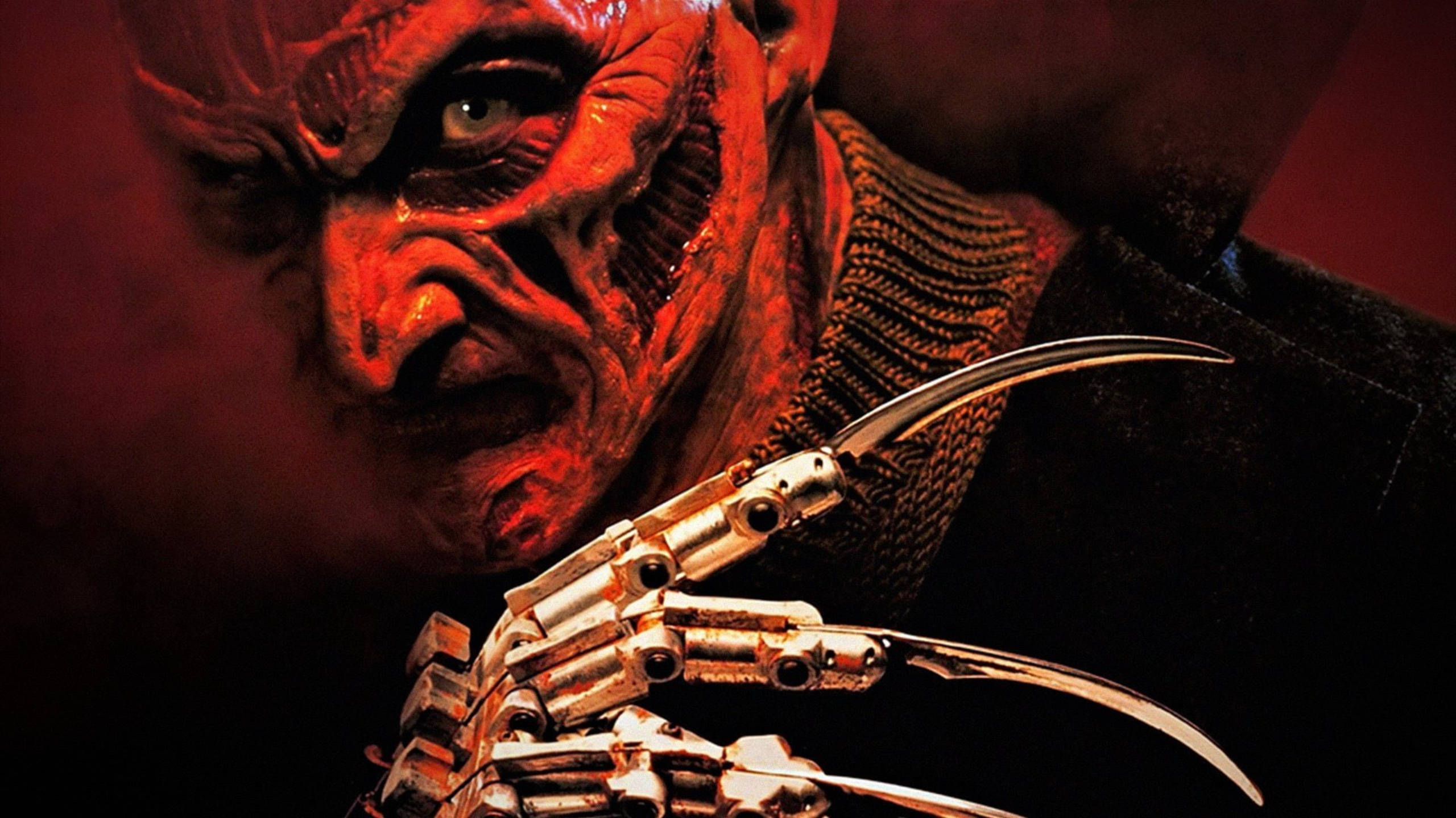 Freddy 桌布 壁紙 — 在戲劇性的紅光下，佛萊迪·克魯格帶著他標誌性的刀片手套的威脅性特寫。