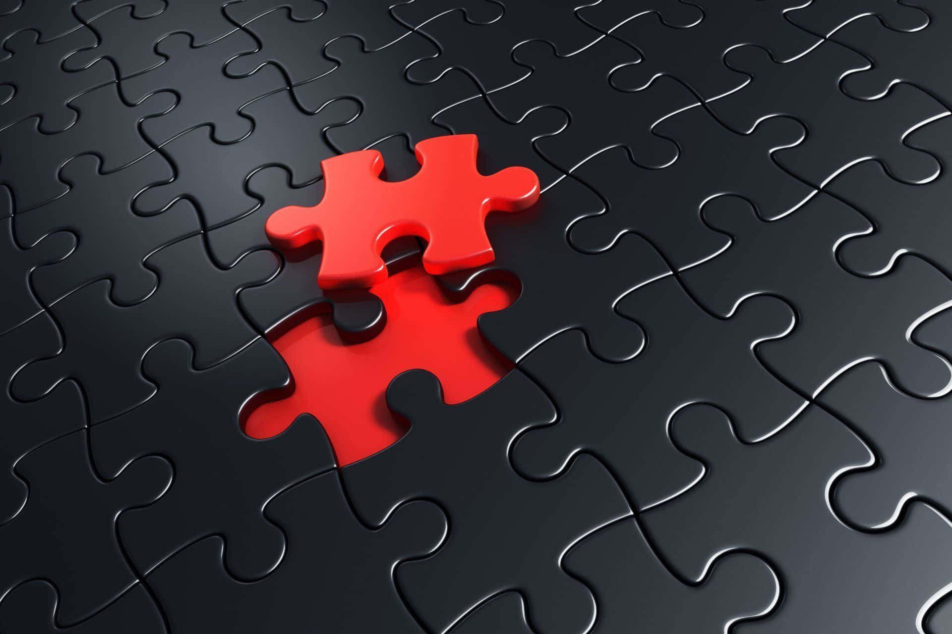 Puzzle 桌布 壁紙 — 在攝影棚燈光下，一塊紅色拼圖碎片懸浮在黑色拼圖網格中缺失的位置上方。
