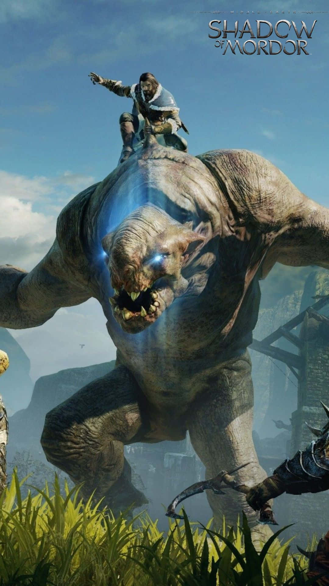 Android Shadow Of Mordor 桌布 壁紙 — 在明亮的藍天下，一名戰士騎著一隻巨大的發光獸人在奇幻景觀中。