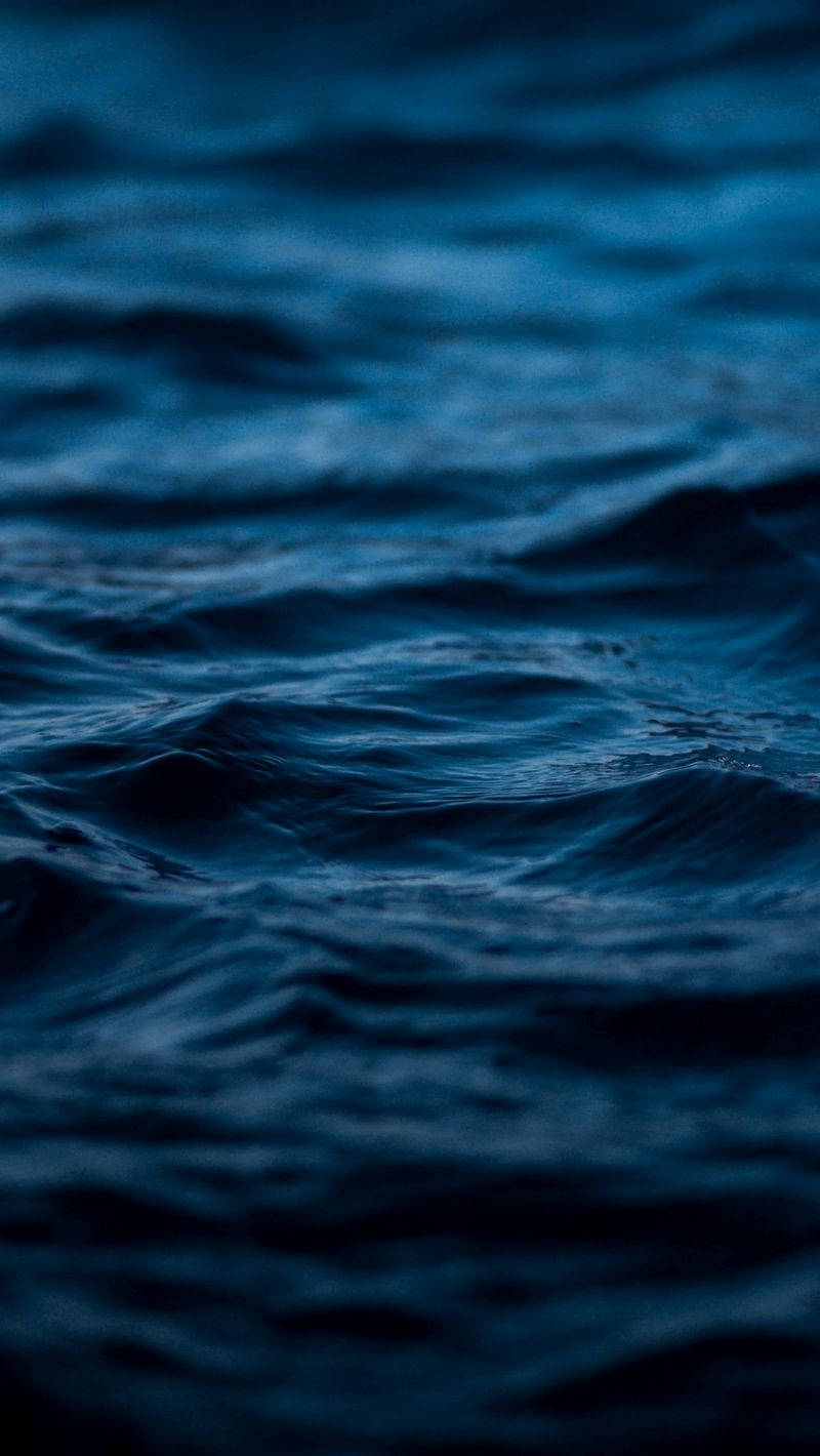 Aesthetic Dark Blue 桌布 壁紙 — 在昏暗暮光下輕輕翻滾的深藍色海浪特寫。