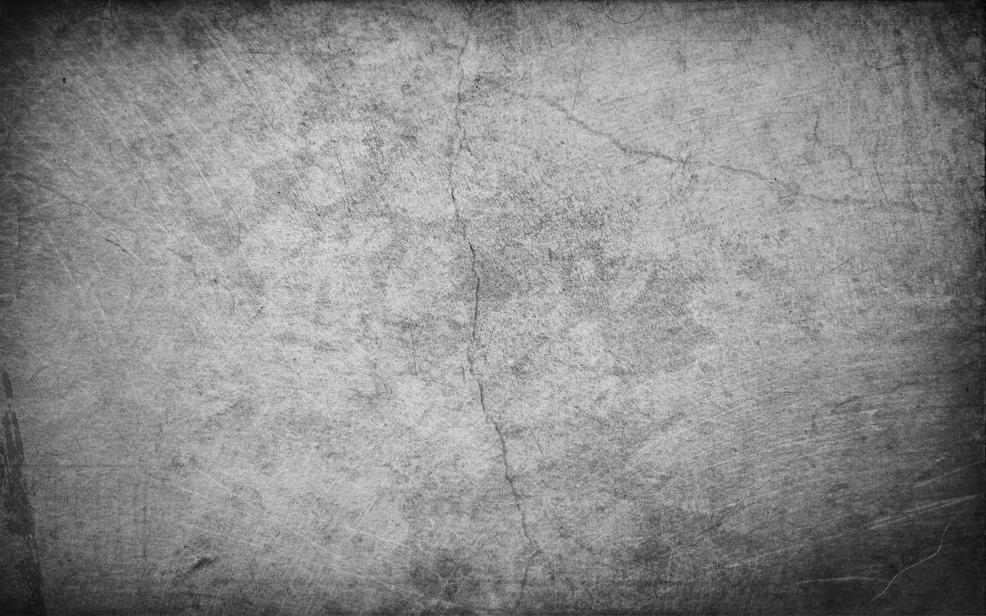 White Grunge 桌布 壁紙 — 在柔和光線下，帶有深刮痕和裂縫的風化灰色混凝土表面。