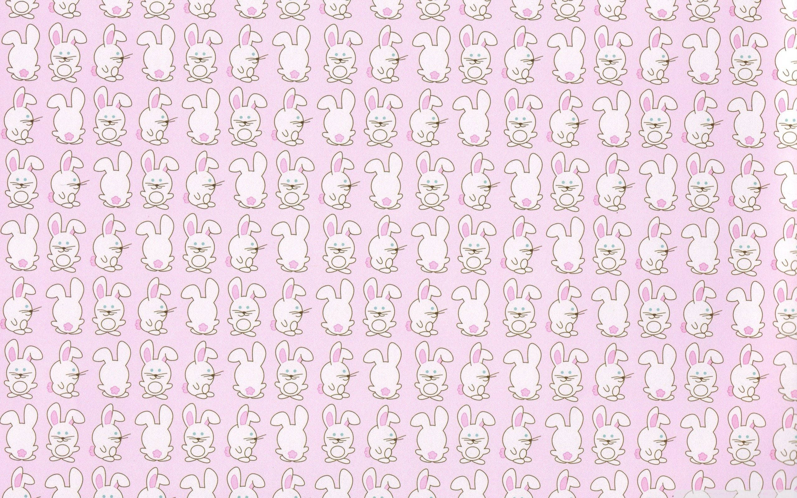 Cute Bunny 桌布 壁紙 — 在柔和的粉紅色背景上，可愛的白色卡通兔子的重複圖案，帶有粉紅色的耳朵和臉頰。