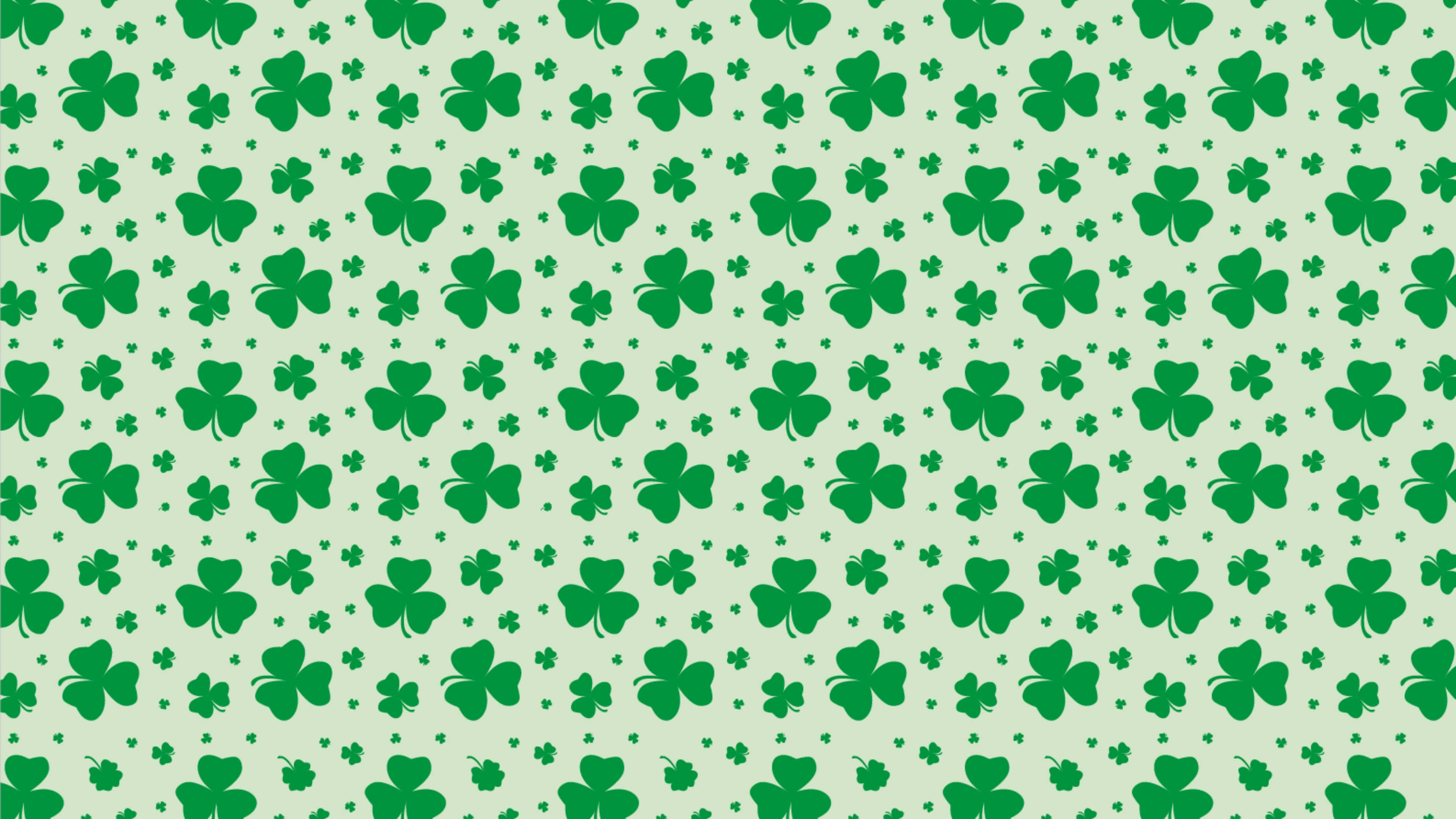 Saint Patricks Day 桌布 壁紙 — 在淡薄荷色背景上重複出現的綠色三葉草和小星星圖案。