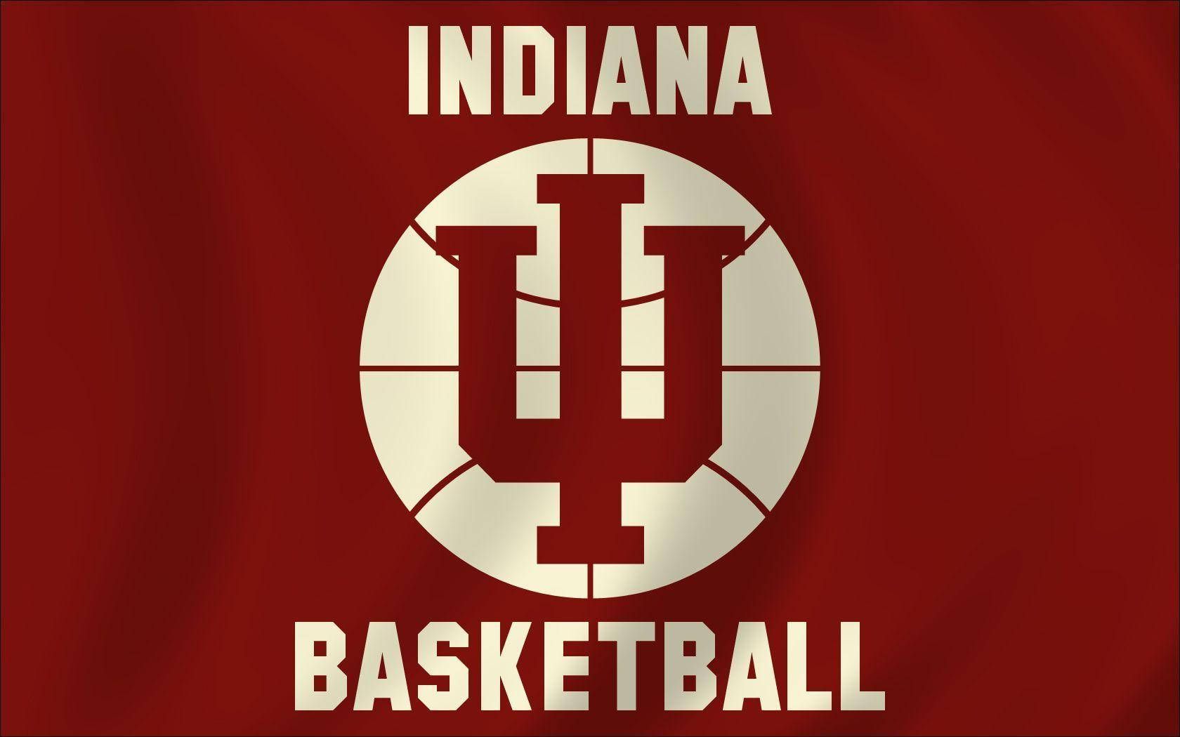 Indiana 桌布 壁紙 — 在深紅色布料上以奶油色呈現大膽的印第安納籃球標誌，帶有細微的摺痕和燈光效果。