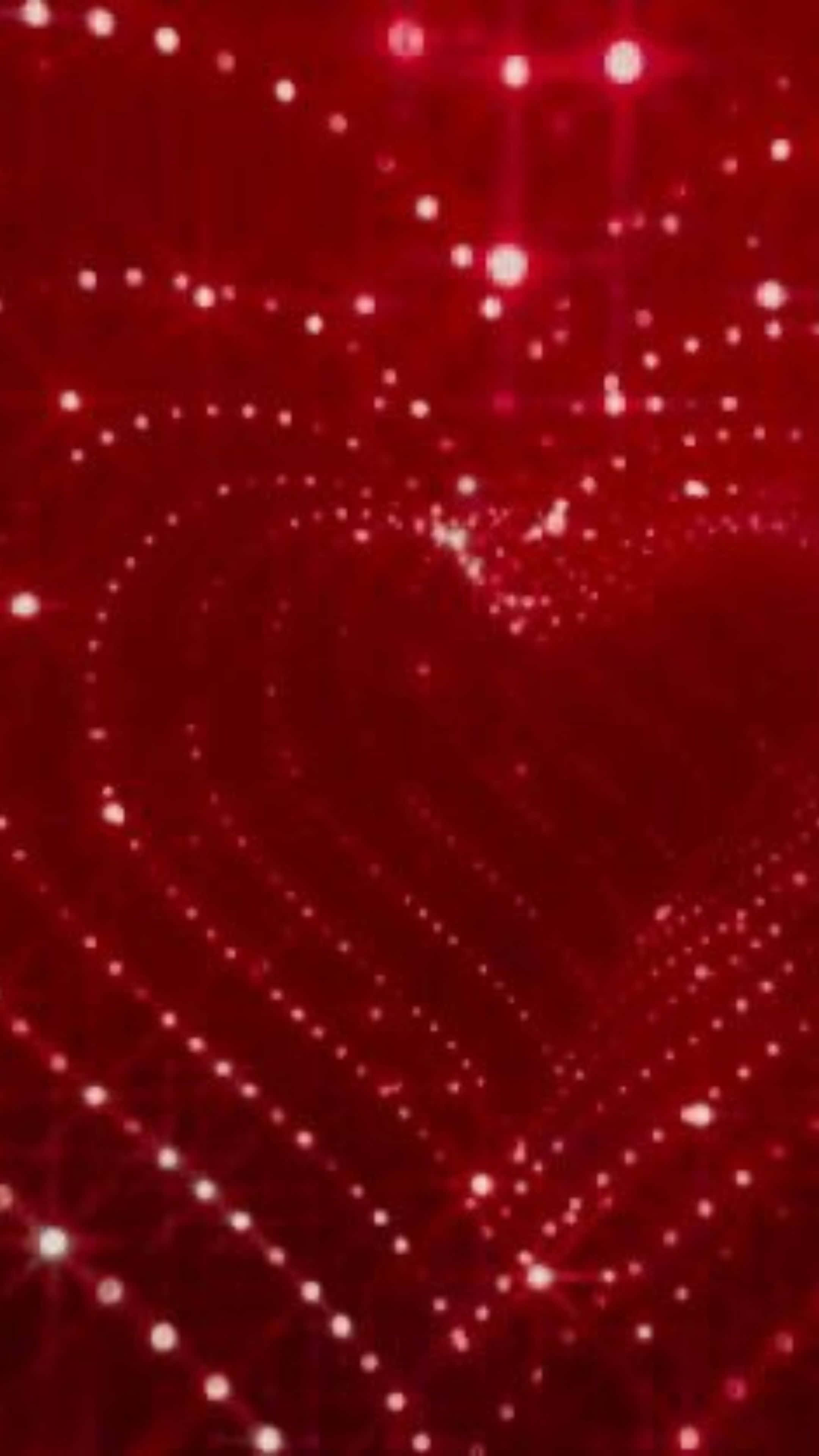 Red Hearts 桌布 壁紙 — 在深紅色背景上由閃爍光粒子形成的發光紅色心形。