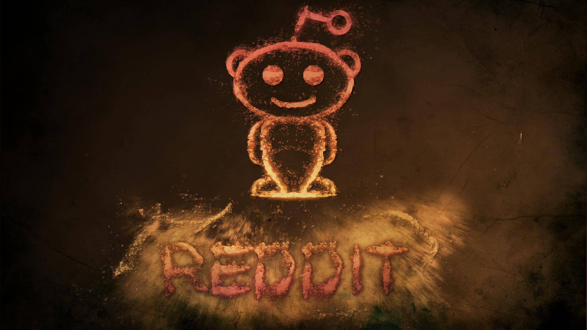 Reddit 桌布 壁紙 — 在深色紋理背景上，用灰塵繪製的發光紅橙色 Reddit 外星人標誌，下方有「REDDIT」字樣。