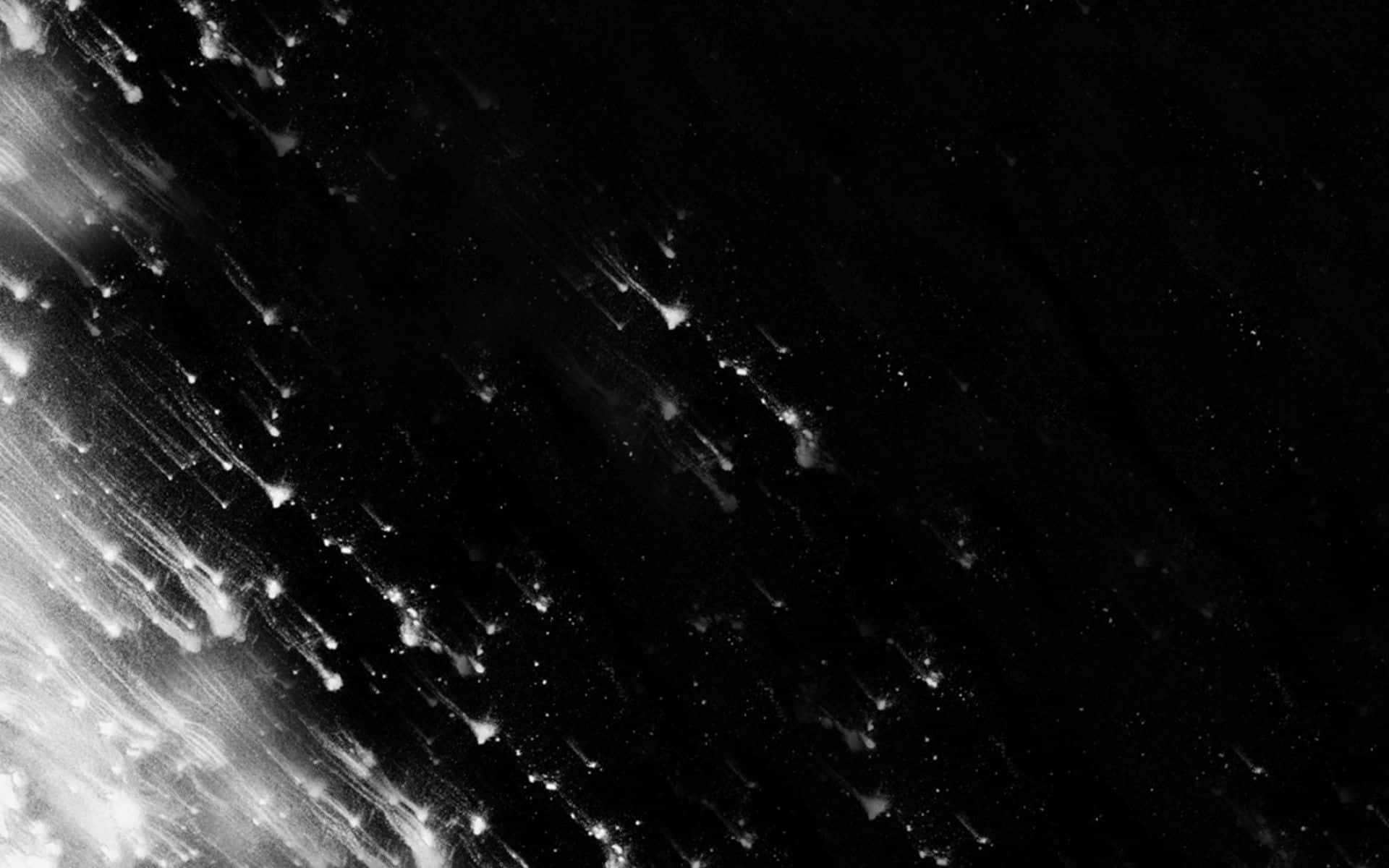 Black Galaxy 桌布 壁紙 — 在深色背景上，光粒子流動的動態黑白抽象構圖。