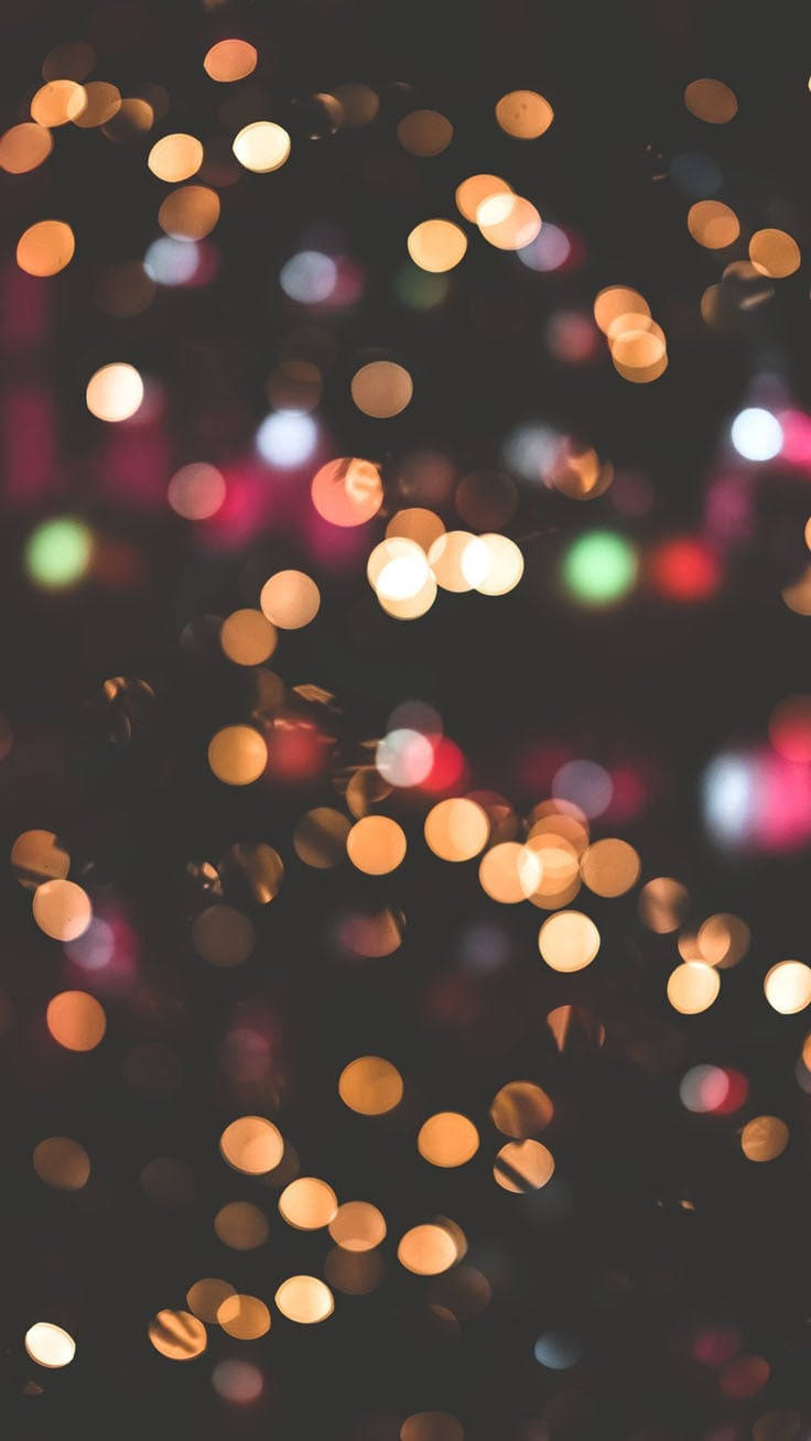 Christmas Lights Aesthetic 桌布 壁紙 — 在深色背景上，溫暖色調的發光燈光營造出夢幻般的散景效果。