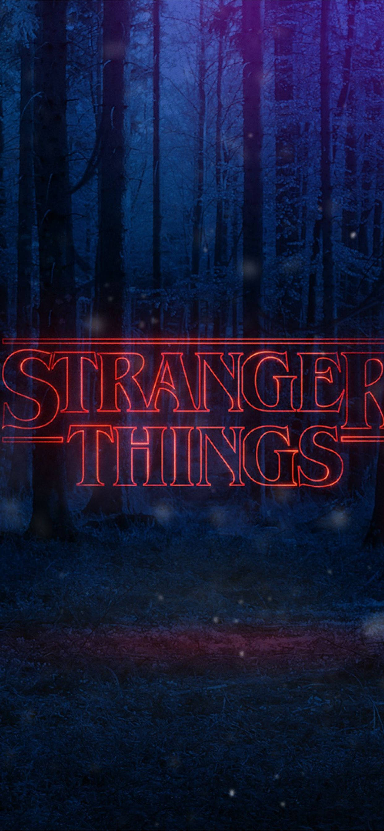 Stranger Things Aesthetic 桌布 壁紙 — 在深藍色暮色天空下，霧氣瀰漫的黑暗森林中，一個發光的紅色「怪奇物語」標題標誌脈動著。