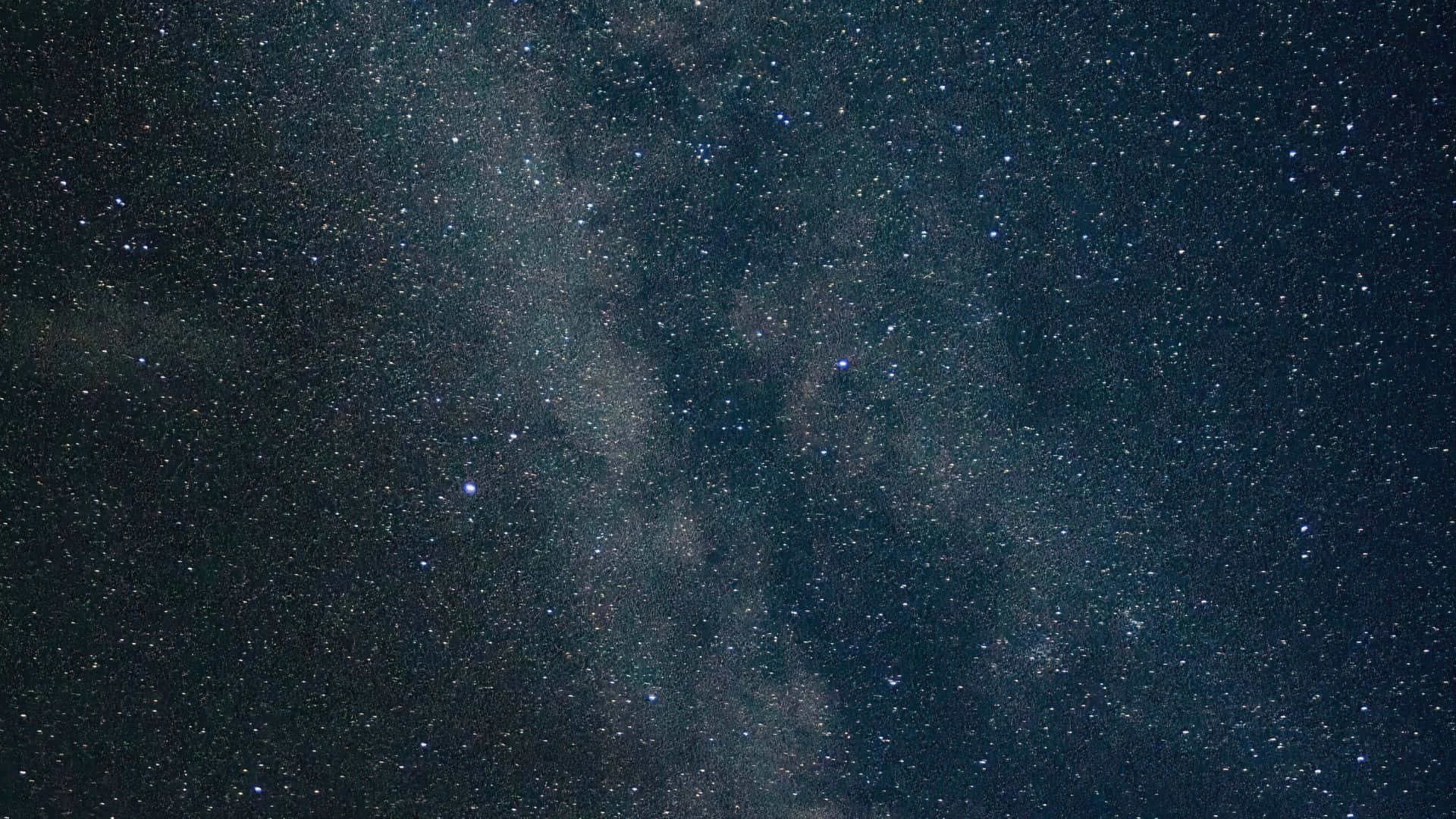 Cosmic Dust 桌布 壁紙 — 在深邃宇宙夜空中，銀河系閃爍著無數星辰的壯麗景色。