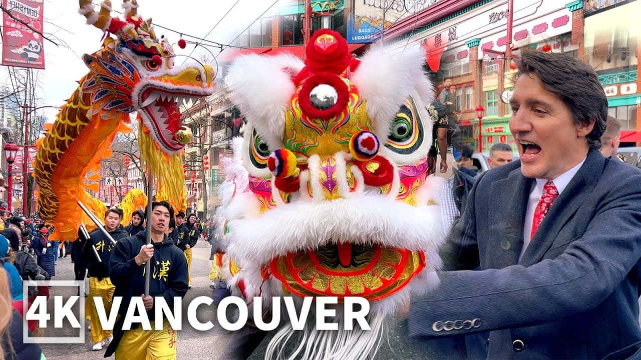 春節 桌布 壁紙 — 在溫哥華熱鬧的街頭節日中，一名身穿西裝的男子在色彩繽紛的舞獅服裝旁開懷大笑。