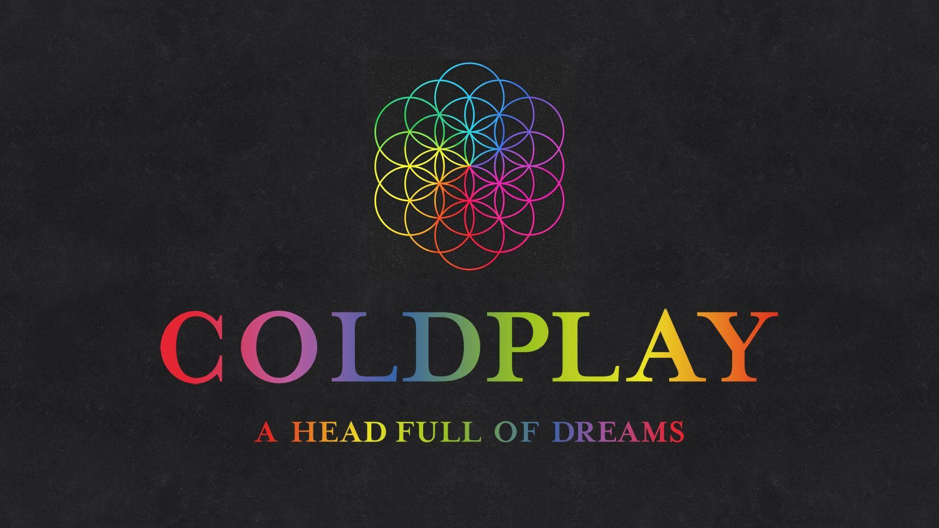 酷玩樂團 桌布 壁紙 — 在紋理黑色背景上，色彩繽紛的Coldplay專輯標題上方有鮮豔的彩虹生命之花標誌。