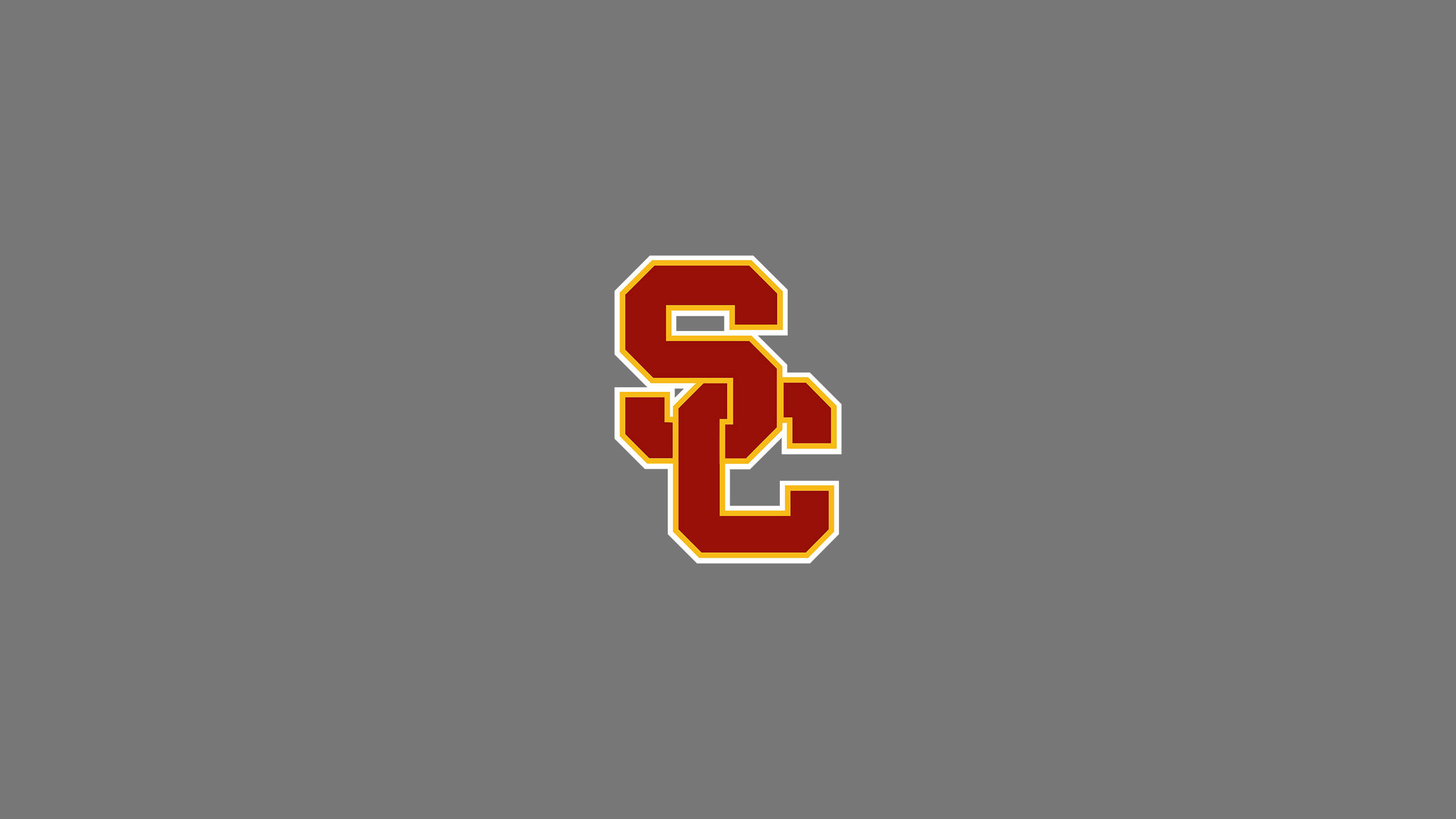 Usc 桌布 壁紙 — 在純灰色背景上居中放置大膽的紅色和金色交錯 SC 標誌。
