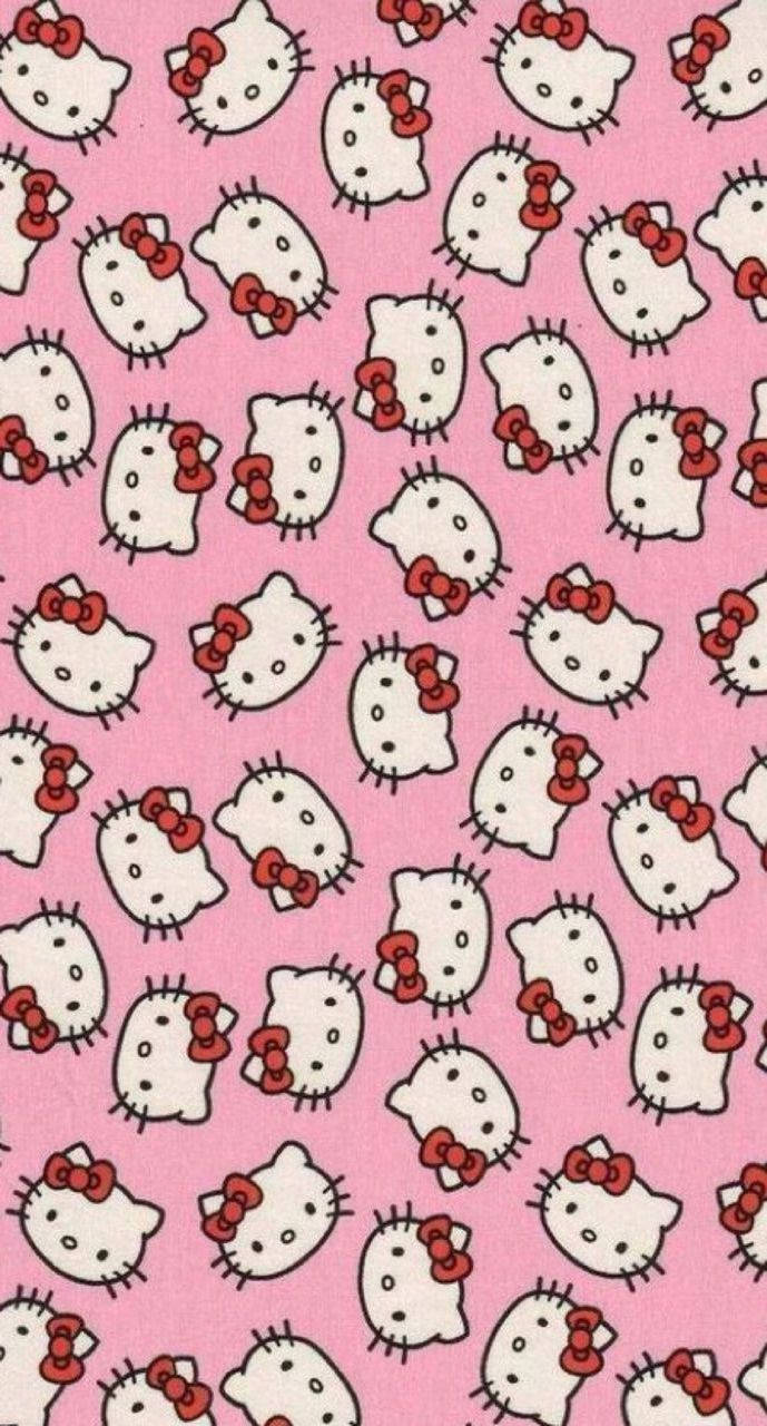 Y2K 桌布 壁紙 — 在純粉紅色背景上重複出現的白色Hello Kitty面孔圖案，帶有紅色蝴蝶結。