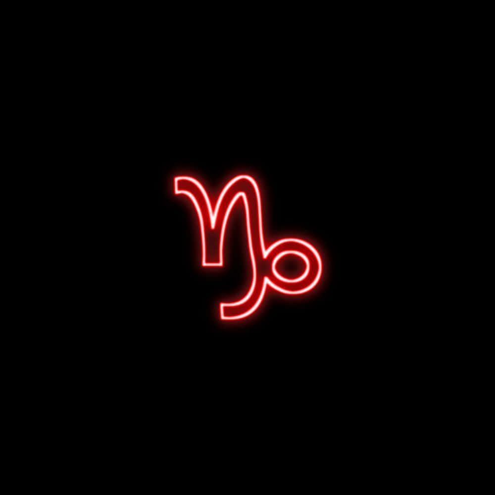 Capricorn Aesthetic 桌布 壁紙 — 在純黑色背景上，一個發光的紅色霓虹燈摩羯座星座符號。