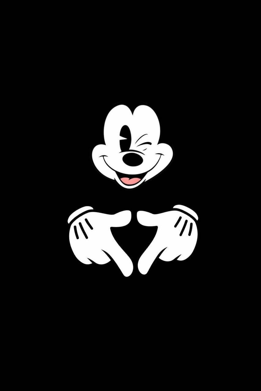 Cute Black And White 桌布 壁紙 — 在純黑色背景上，米奇老鼠眨眼並用雙手指向的極簡白色剪影。