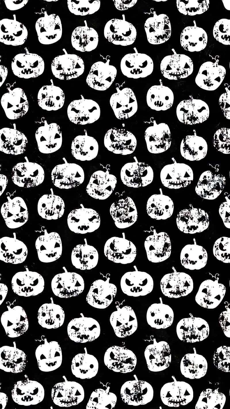 Cute Pumpkin iPhone 桌布 壁紙 — 在純黑色背景上重複出現白色磨損的傑克南瓜燈圖案，帶有各種咧嘴笑的表情。
