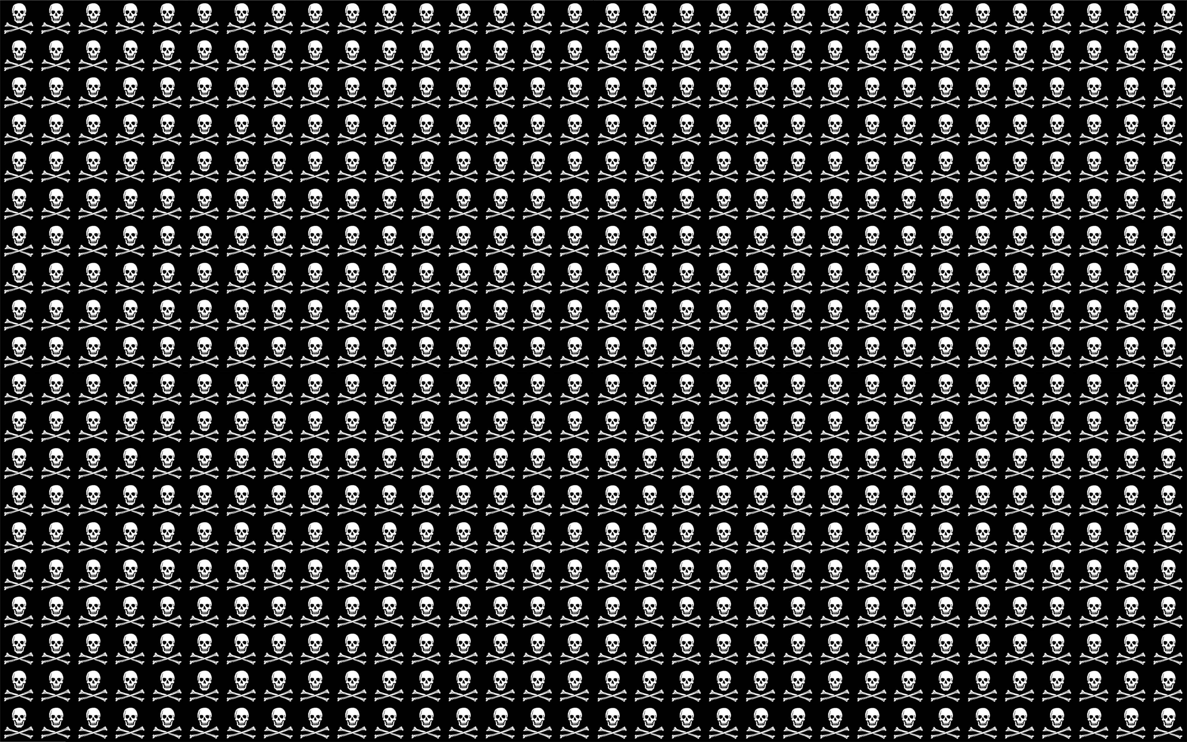 skulls 桌布 壁紙 — 在純黑色背景上重複出現的白色骷髏頭和交叉骨頭圖案。
