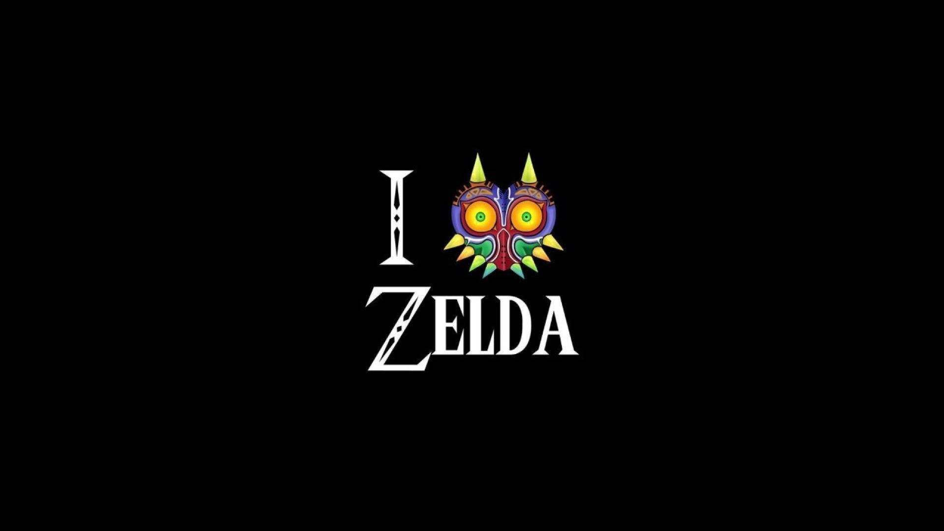 Majora's Mask 桌布 壁紙 — 在純黑色背景中央，有粗體白色「I」和「ZELDA」文字，以及色彩繽紛的穆修拉面具圖示。