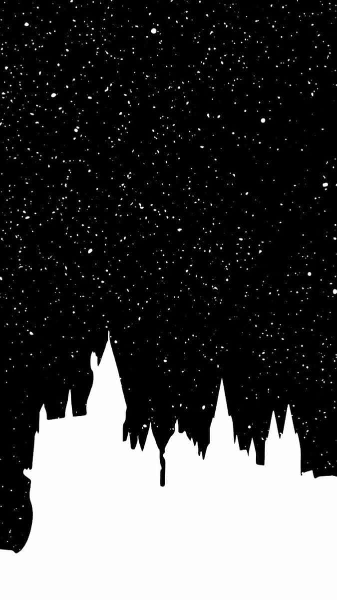 Harry Potter Christmas 桌布 壁紙 — 在繁星點點的夜空背景下，鋸齒狀城堡山峰的清晰黑色剪影，帶有白色斑點。