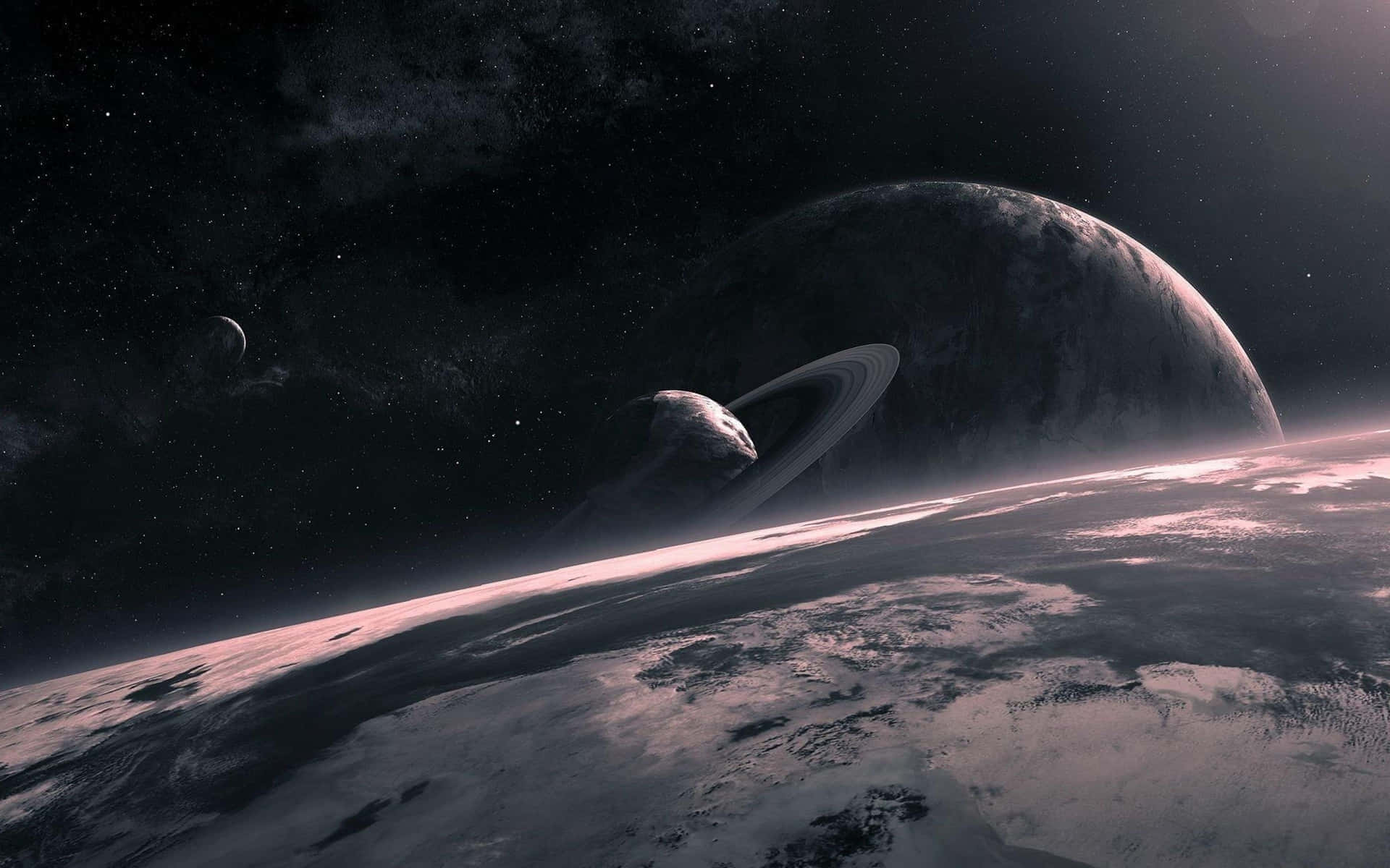 土星 桌布 壁紙 — 在繁星點點的宇宙天空下，一顆雄偉的環狀行星聳立在白雪皚皚的外星景觀之上。