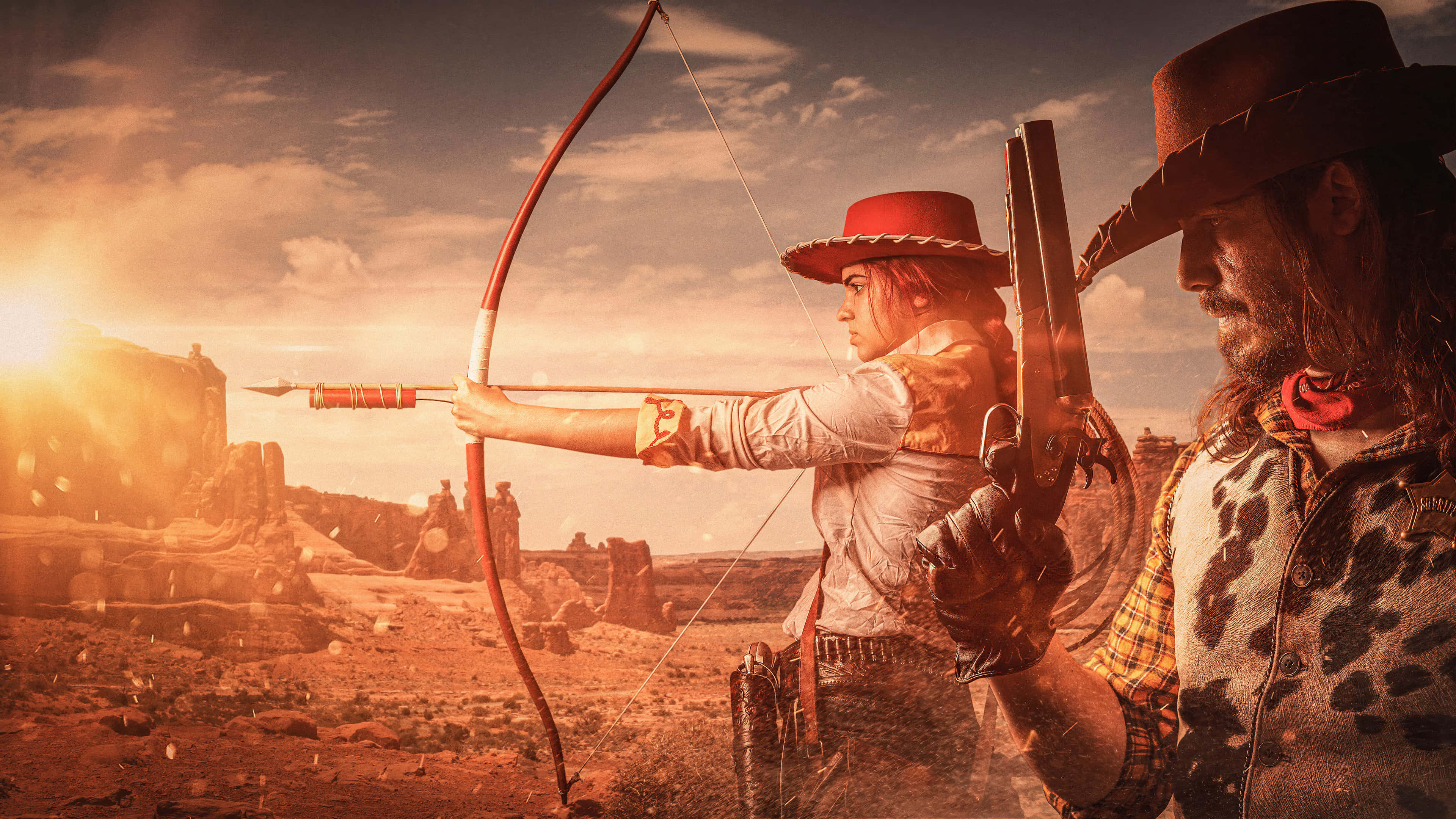 Red Dead Redemption 4K 桌布 壁紙 — 在陽光明媚的沙漠峽谷中，一名女子拉弓，一名男子持步槍，正值黃金時刻。