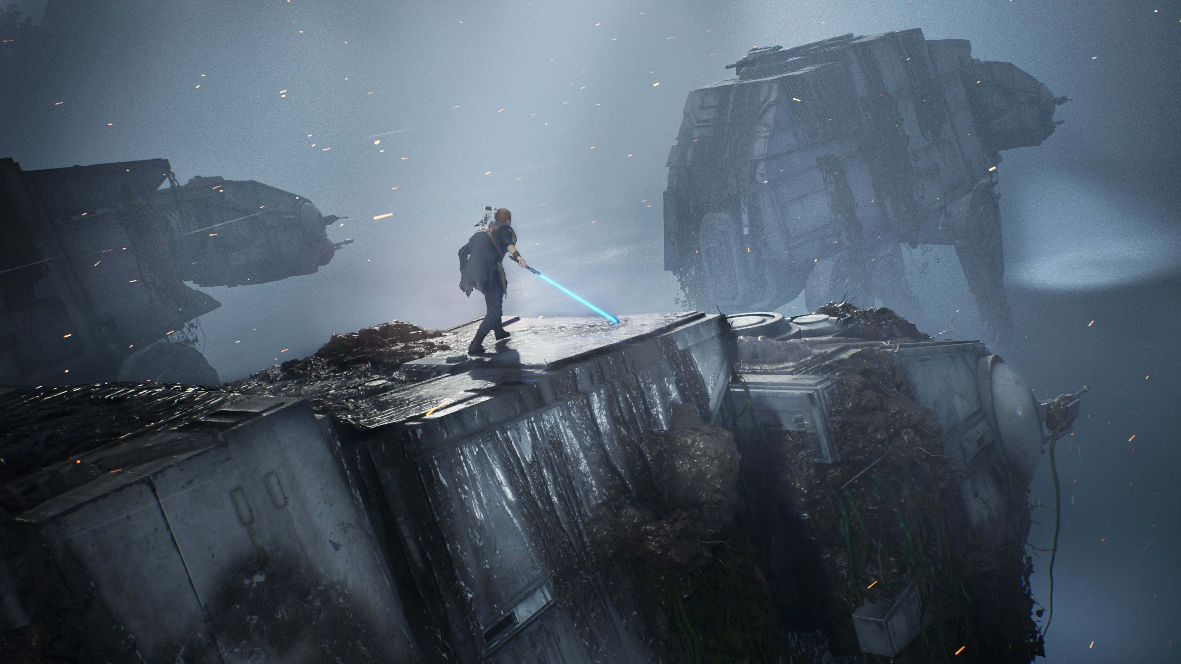 Star Wars Games 桌布 壁紙 — 在霧氣瀰漫的戰場上，一個孤獨的身影在廢墟平台上揮舞著藍色光劍，而巨大的AT-AT步行機正在逼近。