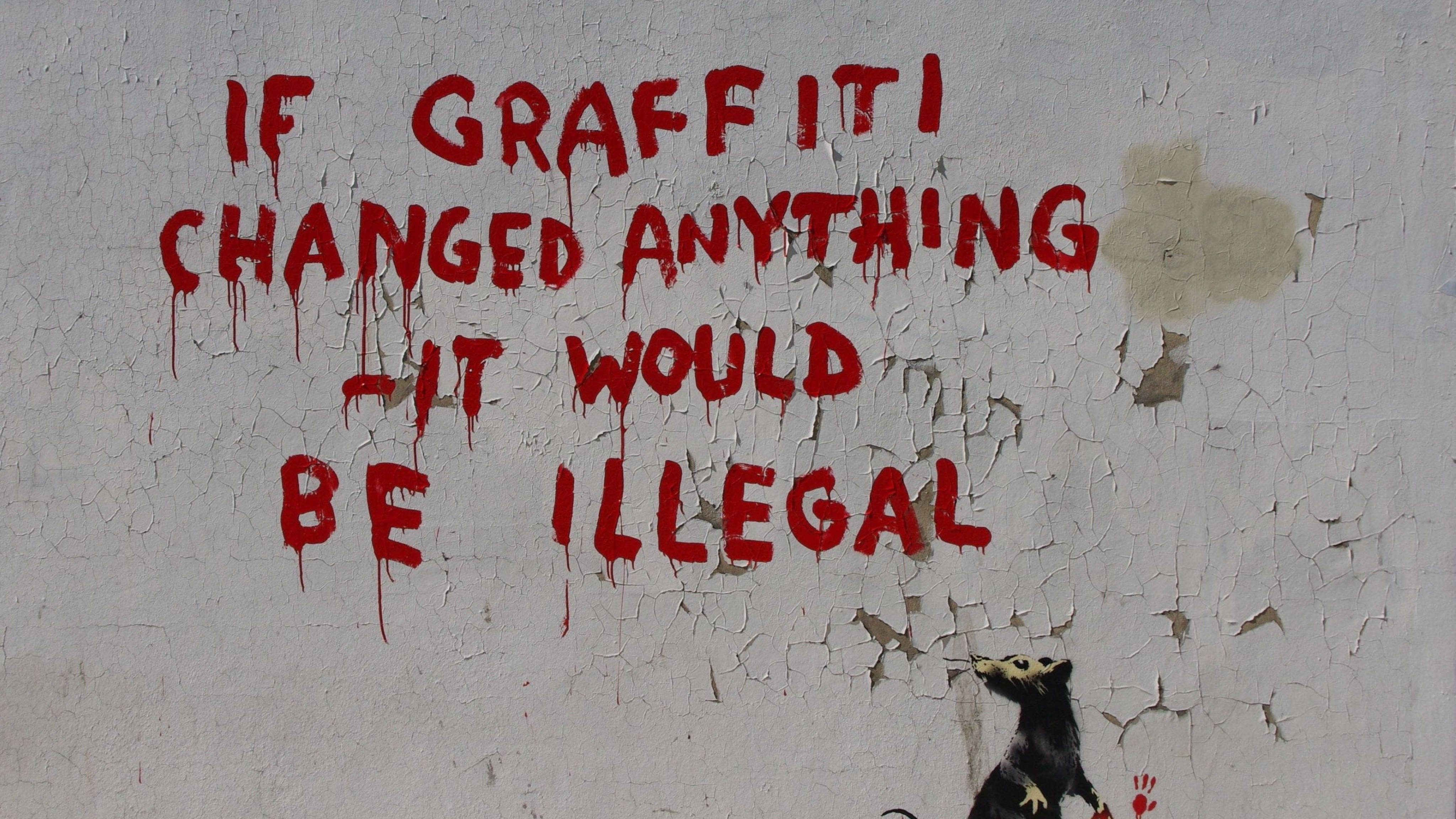 Banksy 桌布 壁紙 — 在風化裂開的牆上，大膽的紅色塗鴉文字宣稱如果塗鴉改變了什麼，它就會是非法的，下面有一隻小老鼠。
