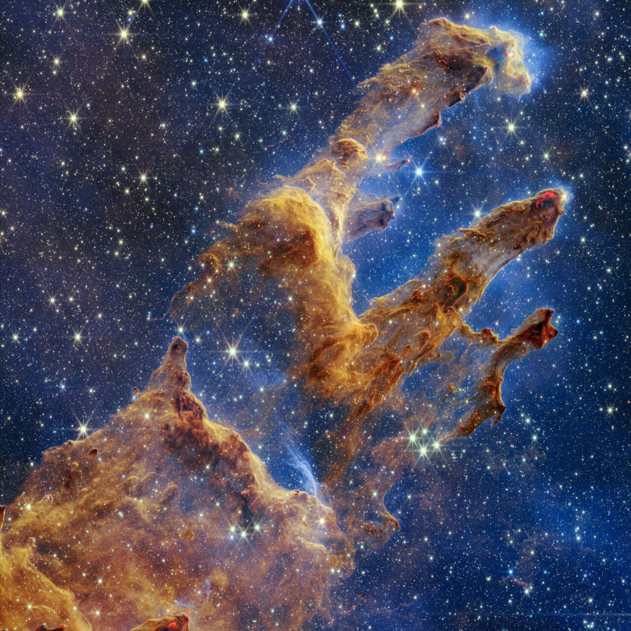 太空 桌布 壁紙 — 在鷹星雲中，一道宏偉的宇宙氣體和塵埃柱，在星場背景下發出琥珀色和藍色光芒。