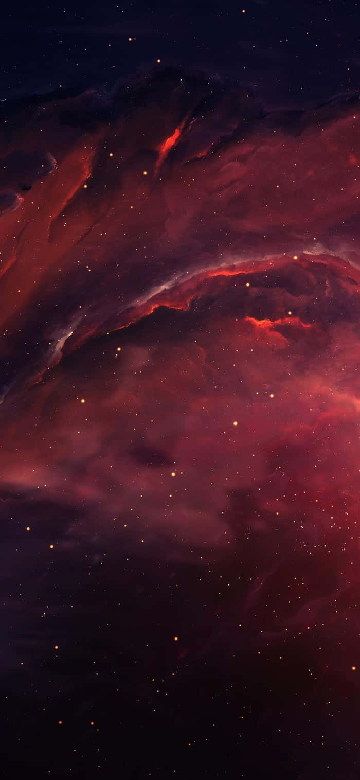 Red Galaxy 桌布 壁紙 — 在黑暗虛空下，一個宇宙星雲以深紅和紫色在星場中旋轉。