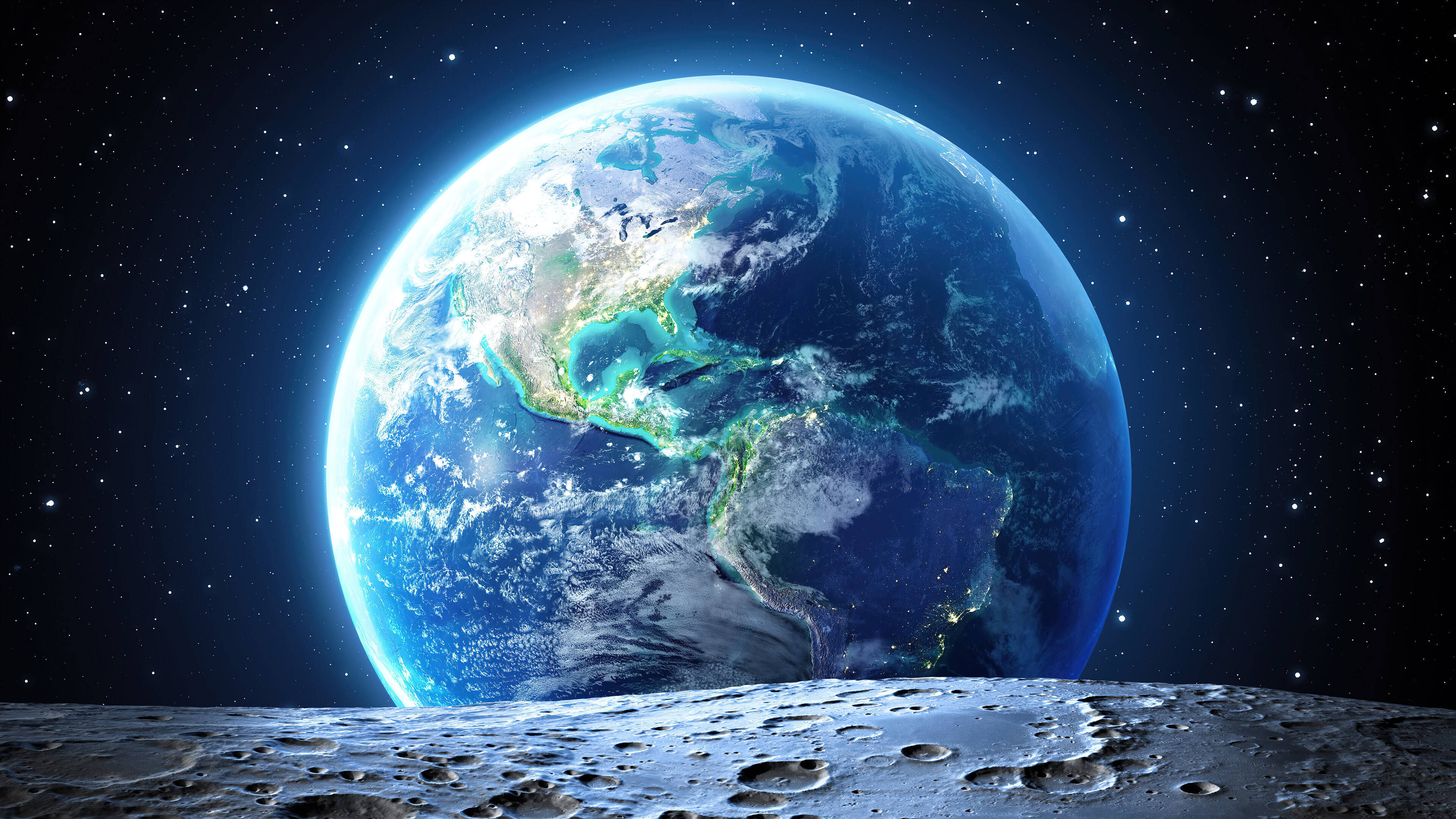 桌布 壁紙 — 地球在月球佈滿隕石坑的表面下，於繁星點點的宇宙天空中發出藍色和綠色的光芒。