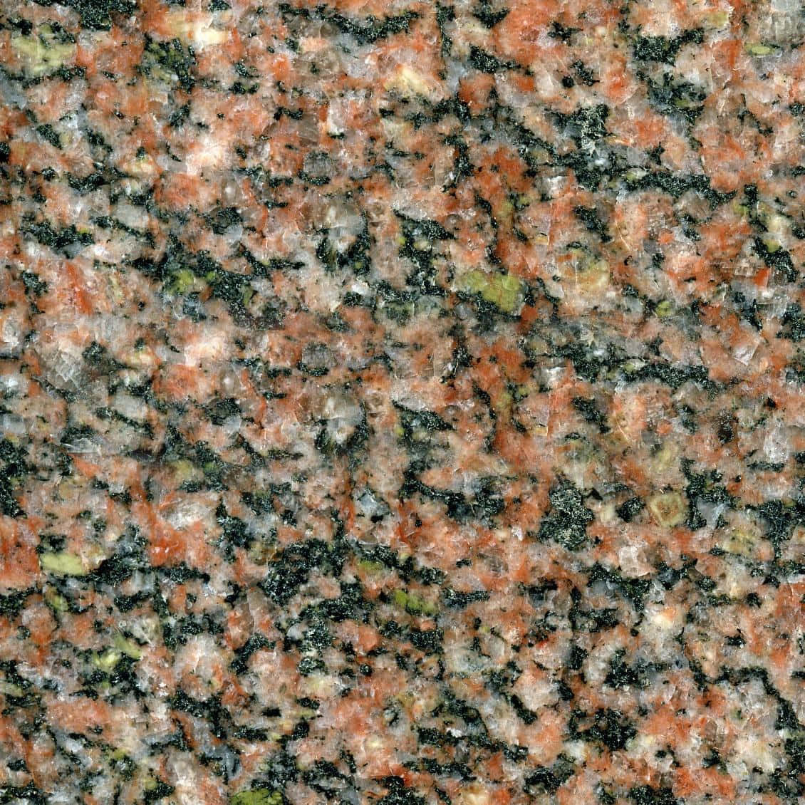 Granite 桌布 壁紙 — 均勻光線下拋光花崗岩的特寫，帶有紅色、黑色和灰色的斑點礦物顆粒。