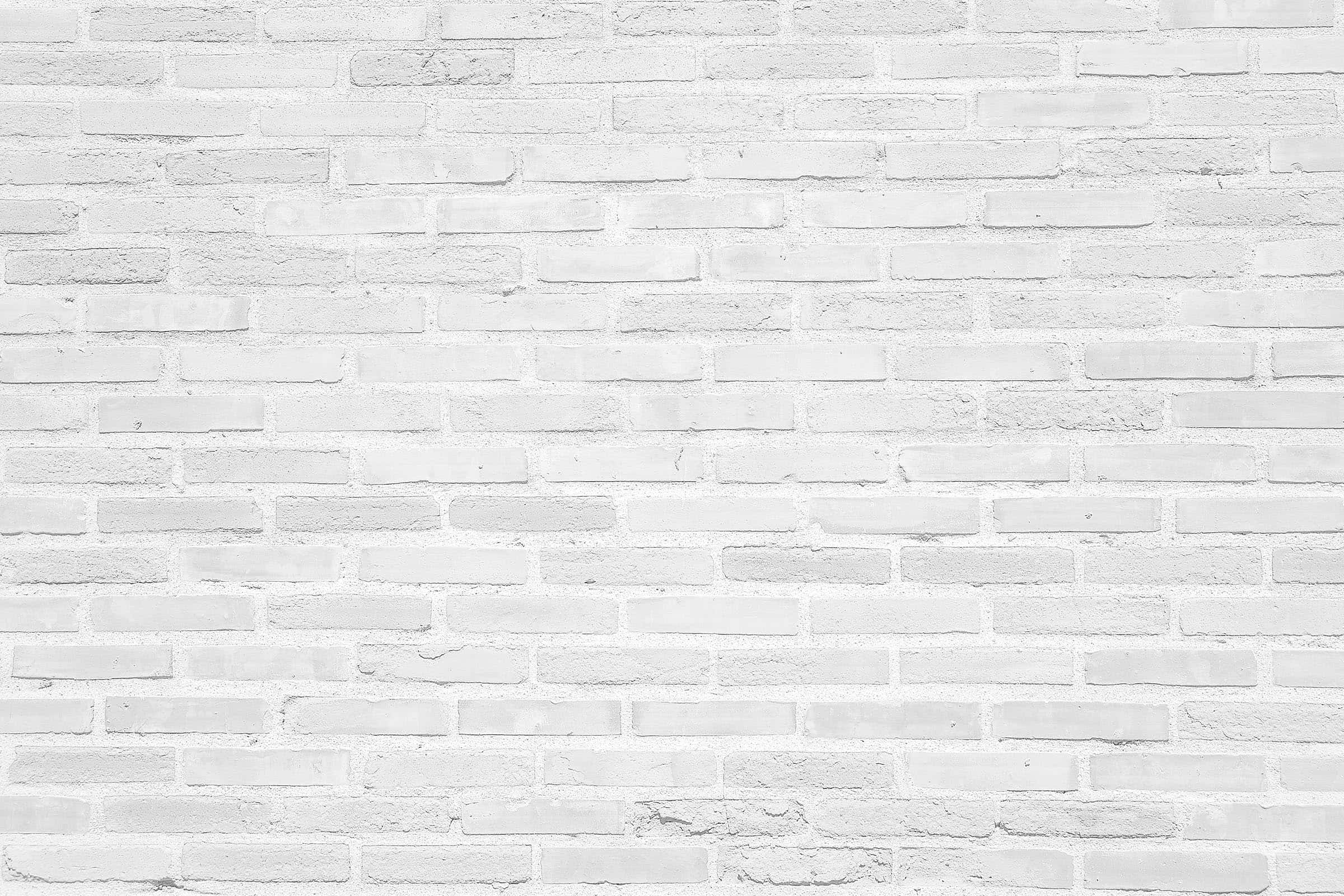 White Brick Wall 桌布 壁紙 — 均勻照明下，帶有細微紋理和砂漿線的清潔白色磚牆。