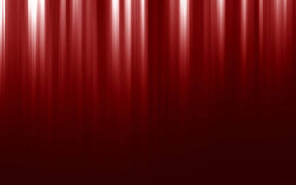 Red Color 桌布 壁紙 — 垂直的紅色窗簾褶皺，被上方柔和發光的光線條紋照亮。