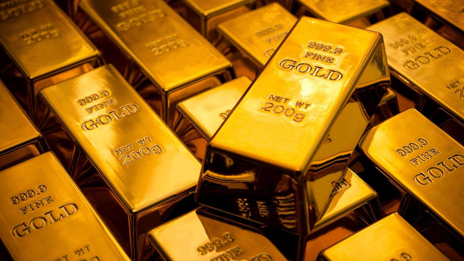 Golden 桌布 壁紙 — 堆疊閃亮的金條，標示純度999.9及每條200克，在特寫鏡頭中反射溫暖光線。