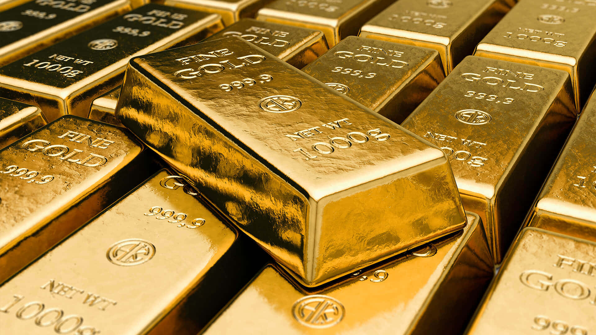金色動態 桌布 壁紙 — 堆疊閃亮的金條帶有雕刻標記，在特寫鏡頭中反射溫暖光線。