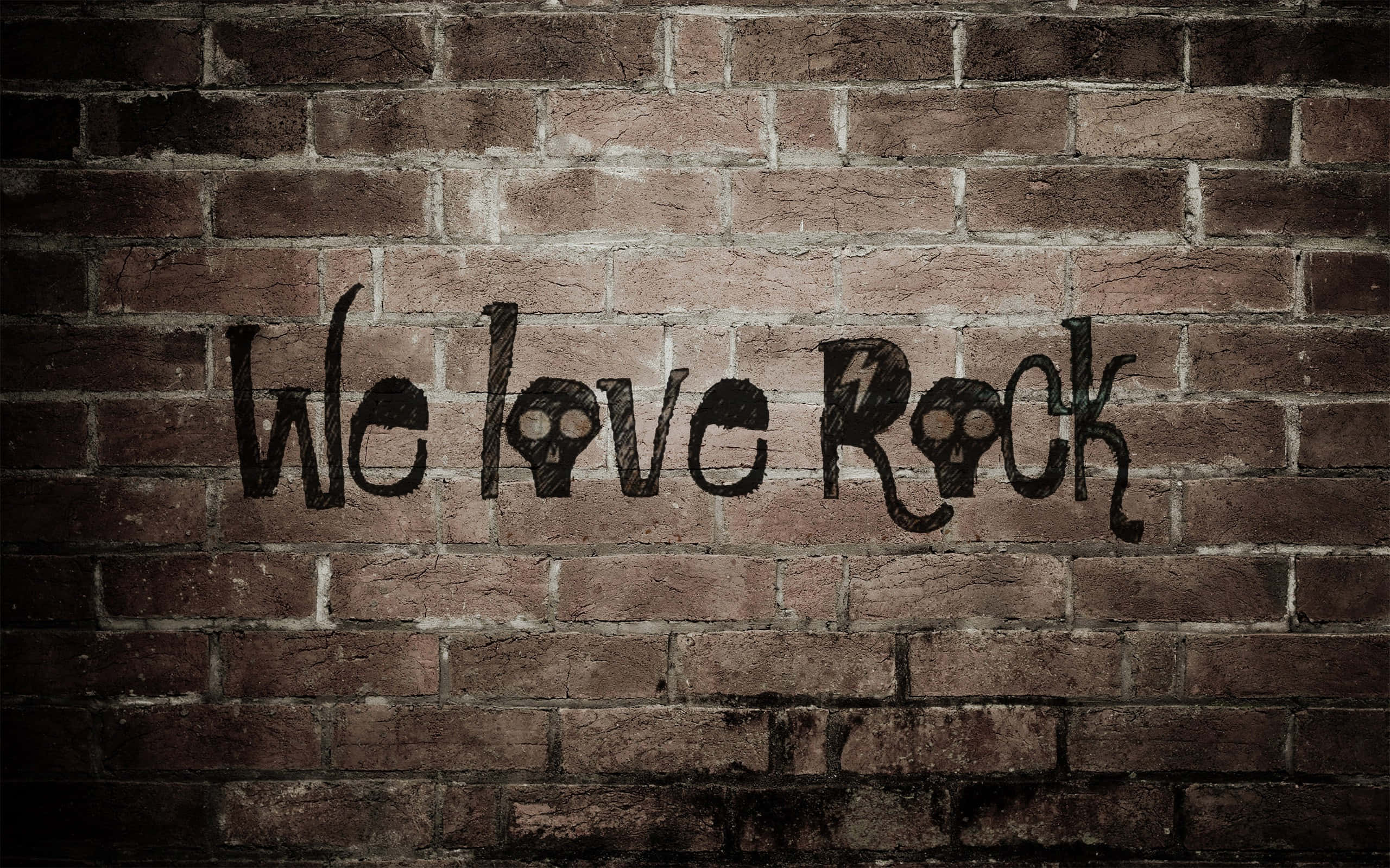 rock and roll 桌布 壁紙 — 塗鴉寫著「We love Rock」，帶有骷髏眼睛和閃電，位於風化的磚牆上。