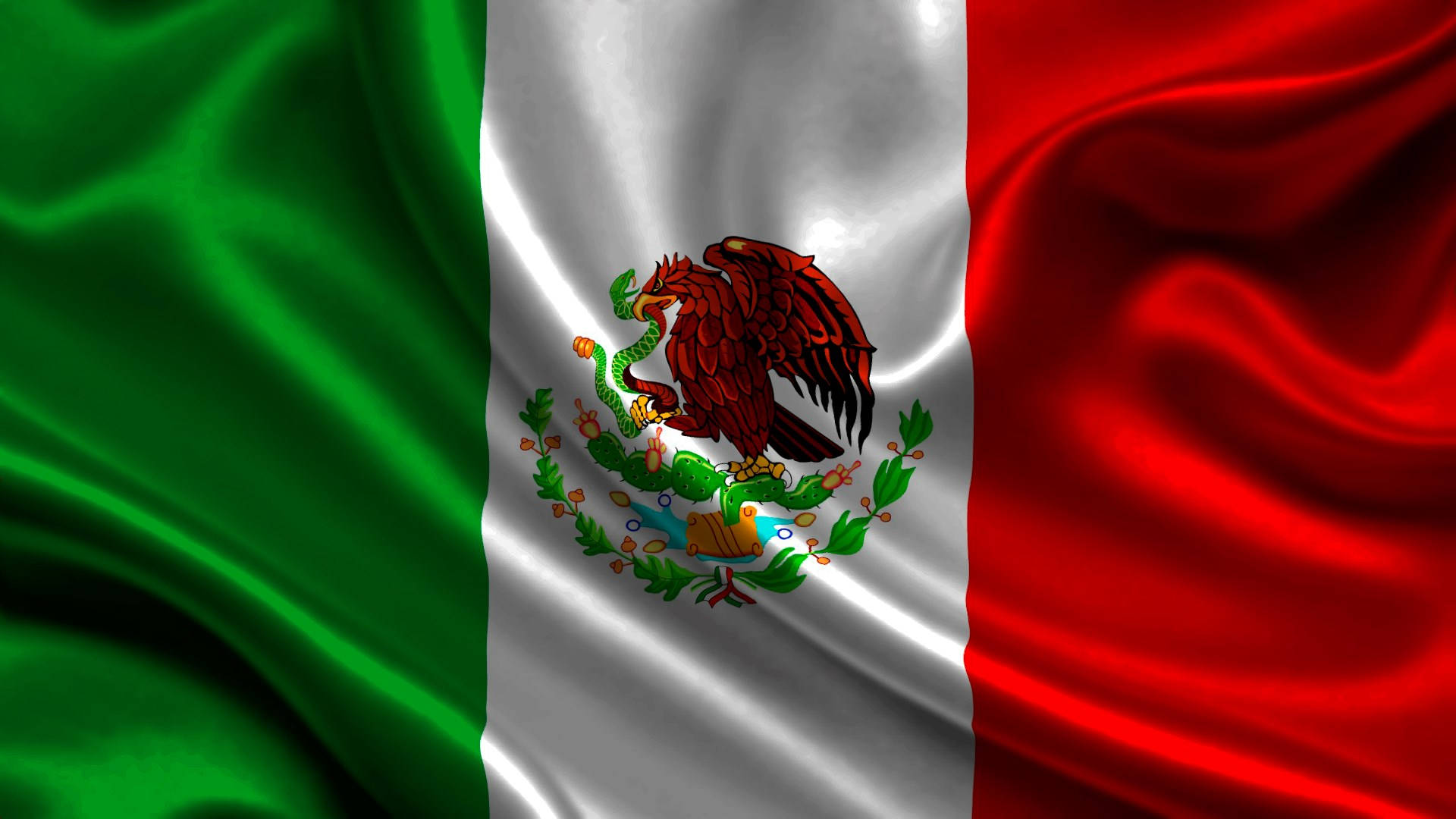 Mexican 桌布 壁紙 — 墨西哥國旗動態飄揚，帶有豐富的綠色、白色和紅色垂直條紋，中央徽章為一隻鷹在仙人掌上吞噬一條蛇。