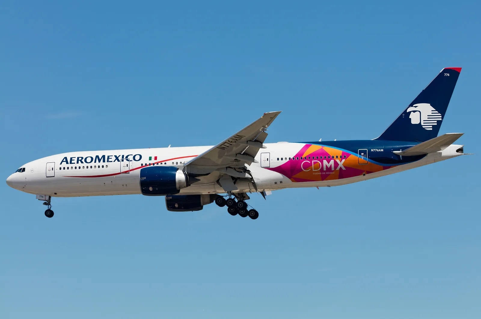 Plane 桌布 壁紙 — 墨西哥航空波音777以鮮豔的CDMX塗裝，在晴朗藍天下放下起落架降落。