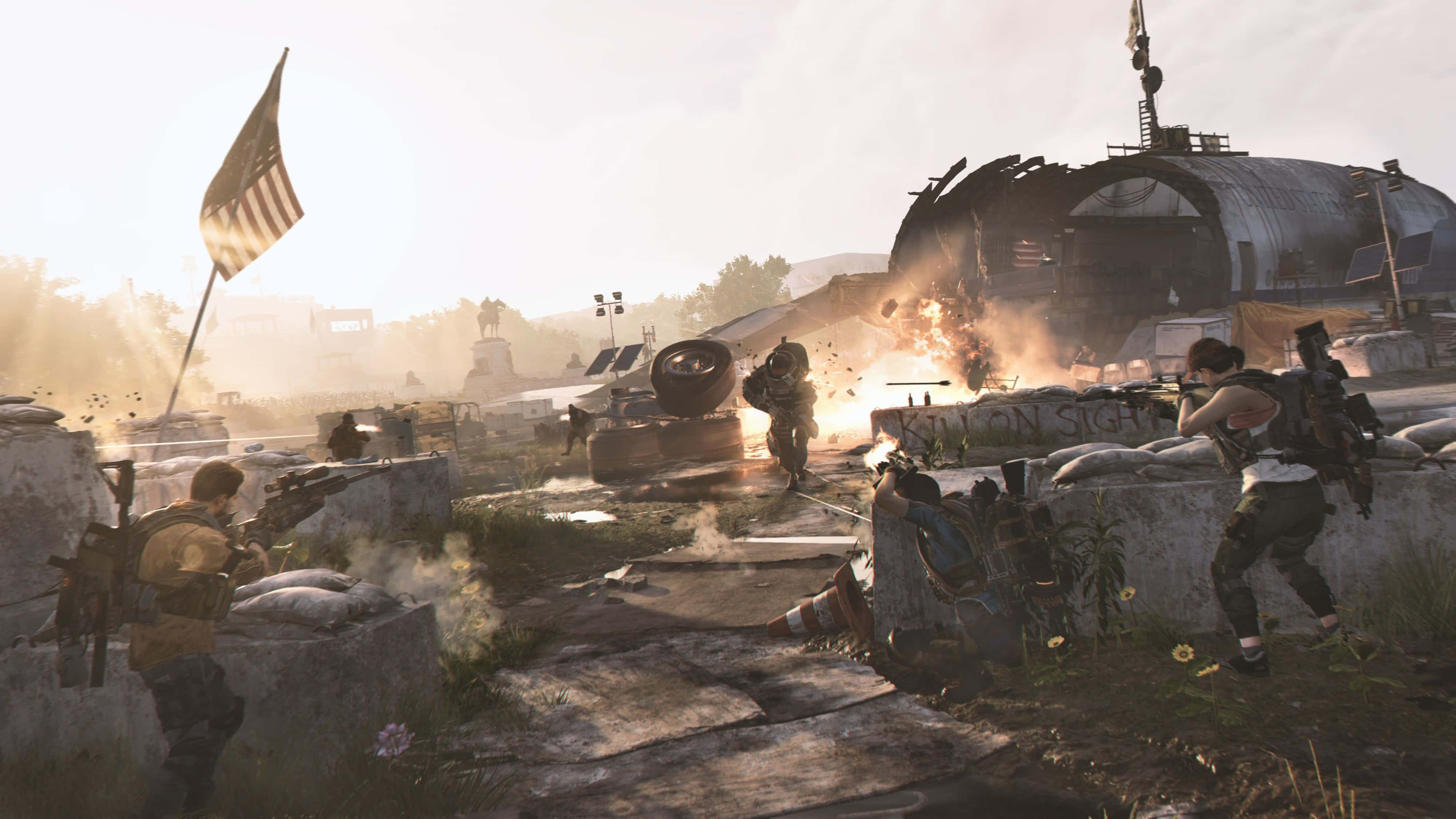 The Division 2 4K 桌布 壁紙 — 士兵在瓦礫和爆炸中戰鬥，在朦朧的陽光下，遠處飄揚著美國國旗。