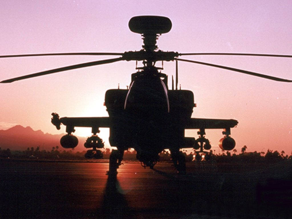 Black Hawk Helicopter 桌布 壁紙 — 夕陽下，背景有山脈，軍用直升機在跑道上的剪影。