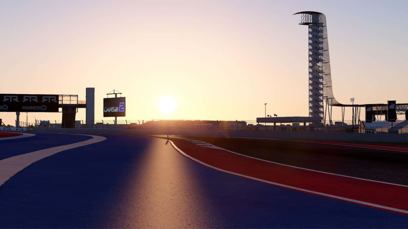 Race Track 桌布 壁紙 — 夕陽在時尚的藍紅賽道上閃耀，現代塔樓和標誌在天空的映襯下形成剪影。