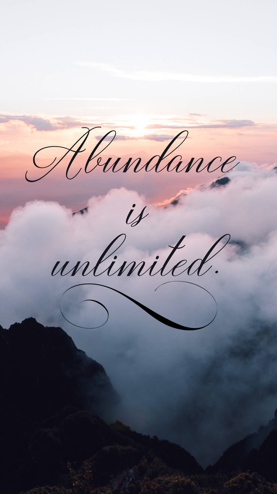山頂在日落時聳立於雲層之上，帶有文字 abundance is unlimited。 — 顯現 GIF 壁紙