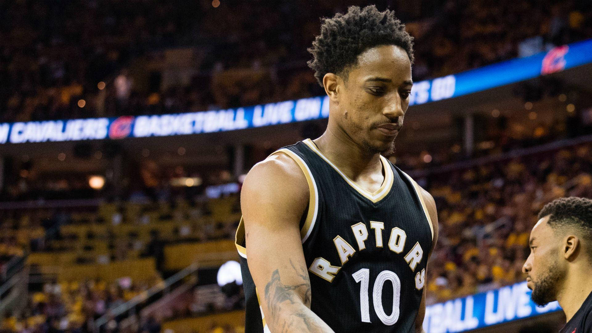 NBA 桌布 壁紙 — 多倫多暴龍隊籃球運動員身穿10號球衣，在比賽中專注站立，背景是模糊的體育場燈光和人群。